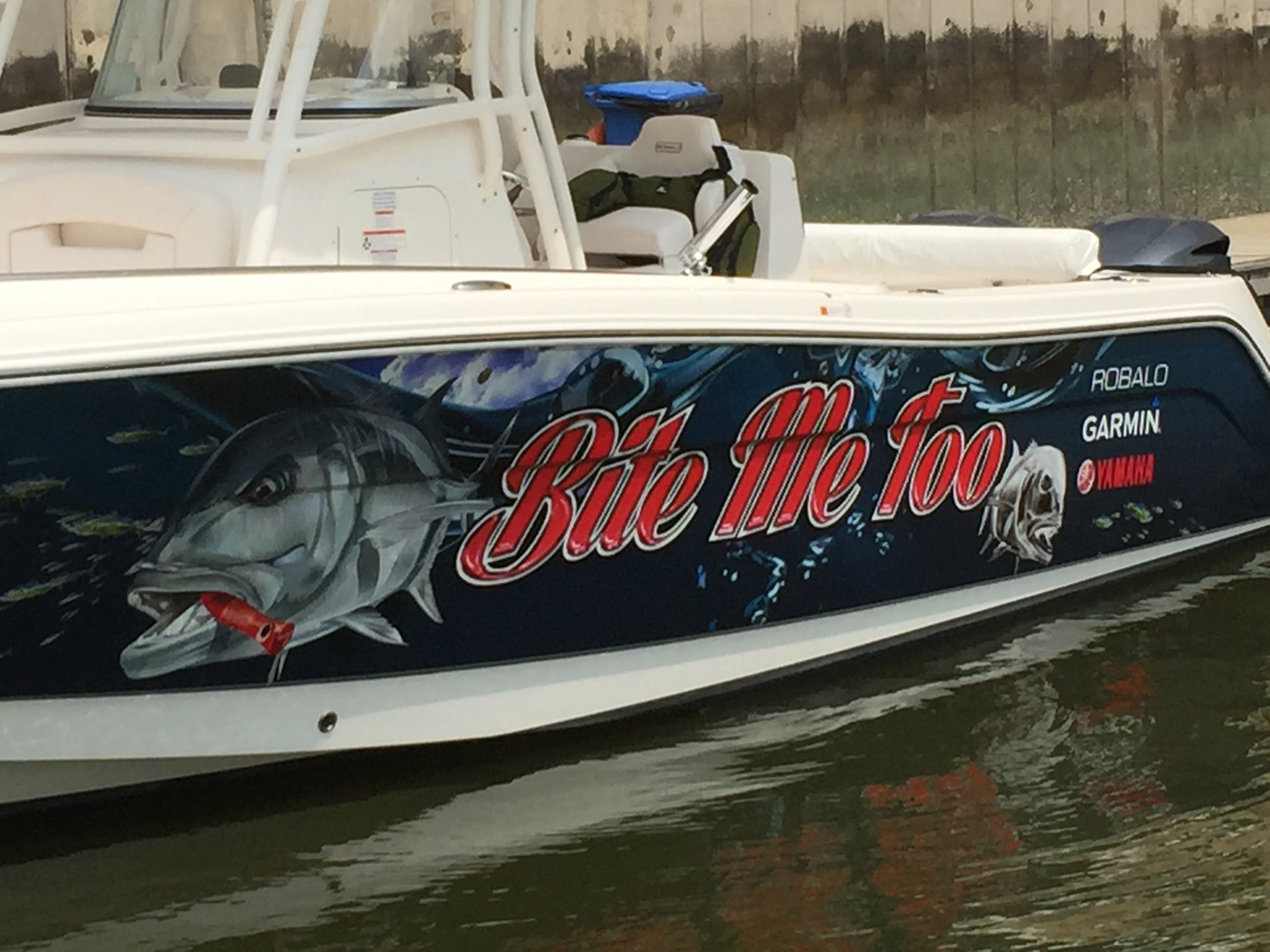 Fishing boat with a lit customised full exterior boat wrap.