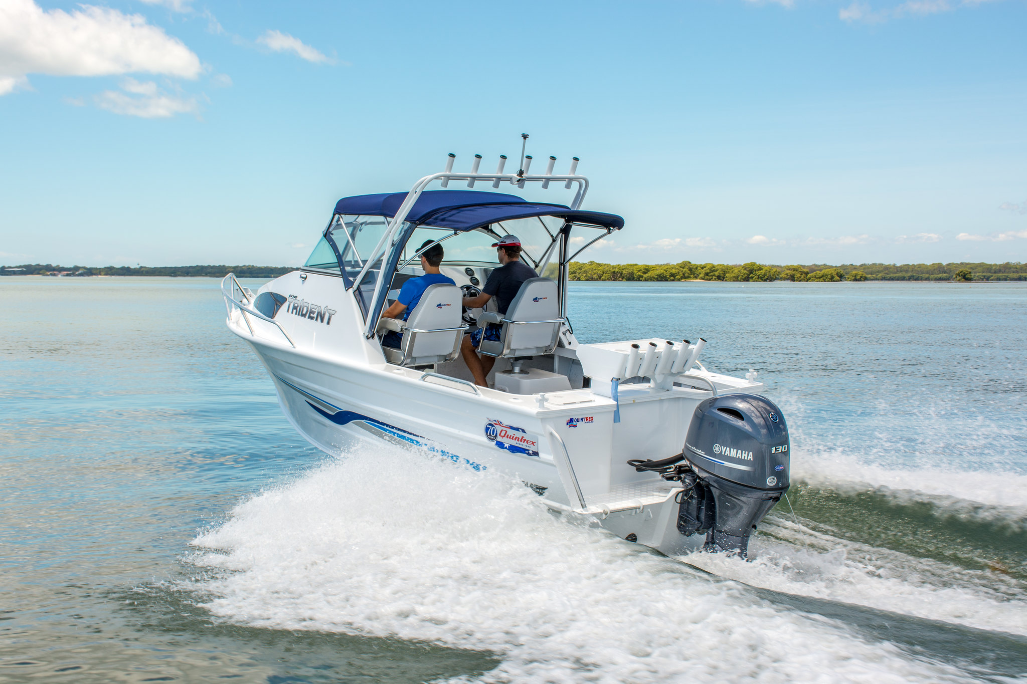 Two men operating a Quintrex boat out on the water.