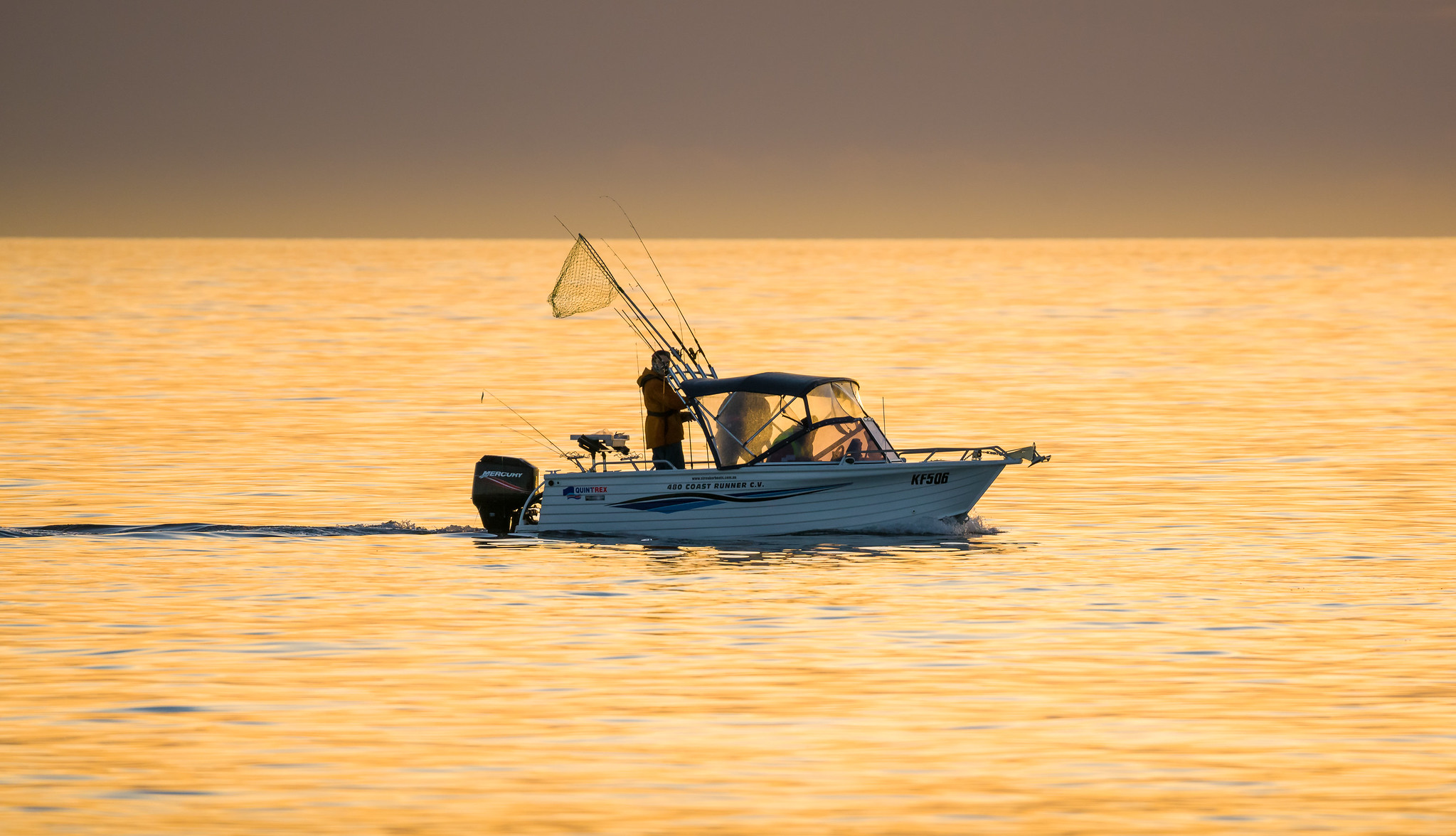 A wide shot of a Quintrex fishing boat at sea.