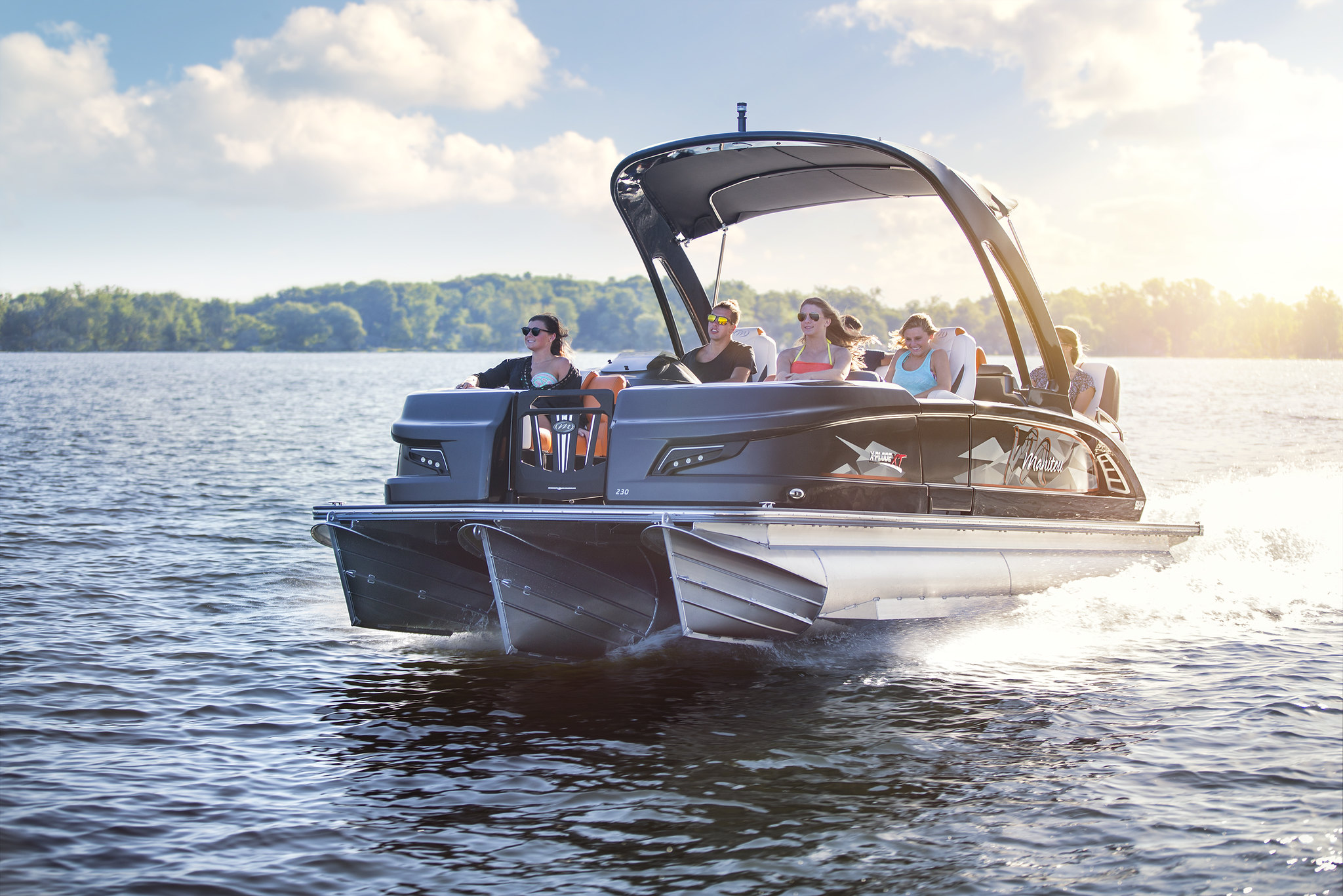 A group of people onboard a Manitou Pontoon. Photo by Greg VanWagenen