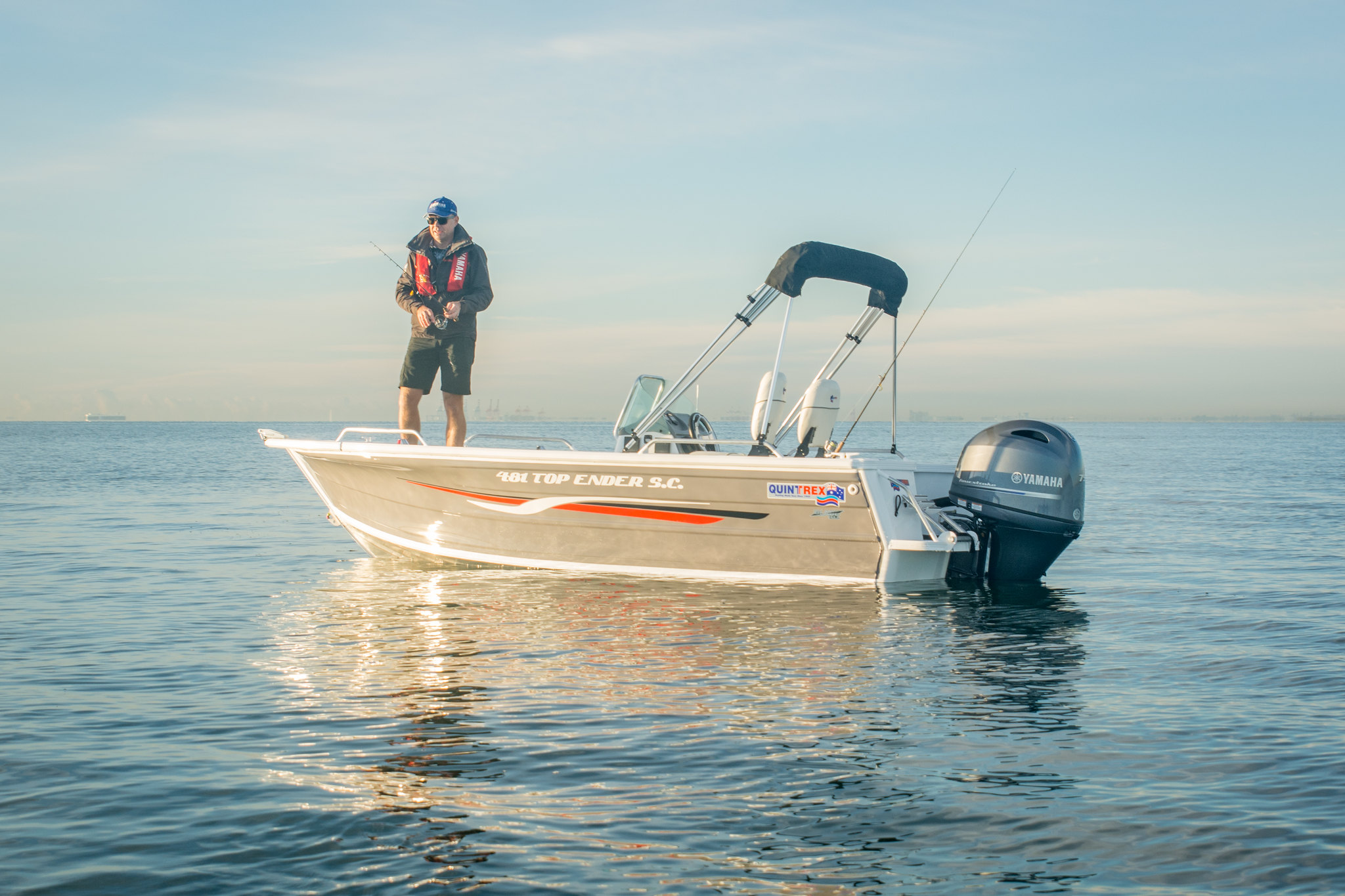 A man standing on a Quintrex Top Ender boat