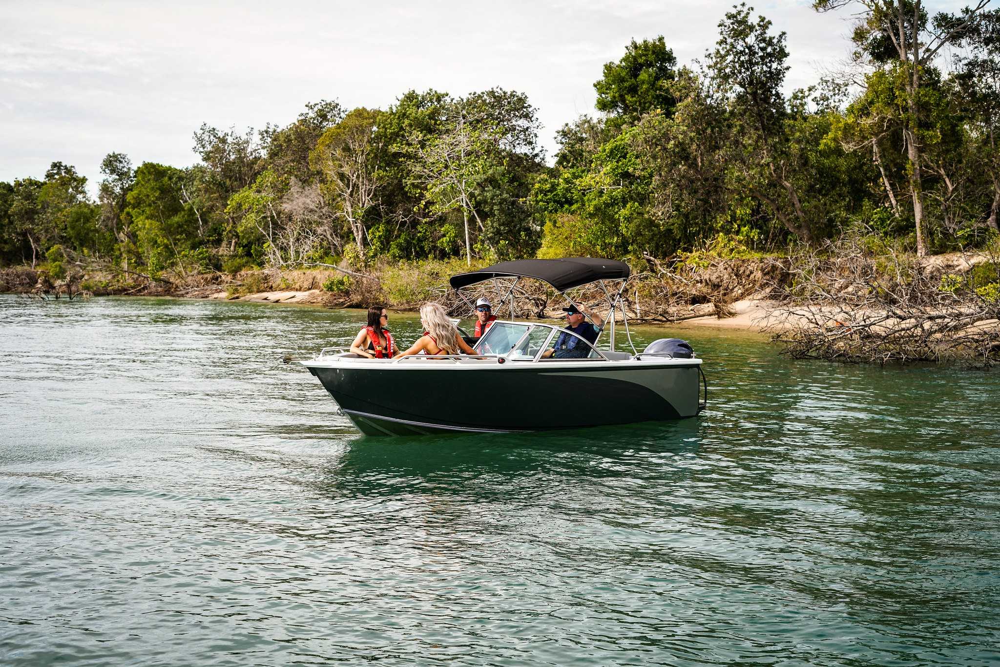 People aboard a leisure craft while boating on a lake.