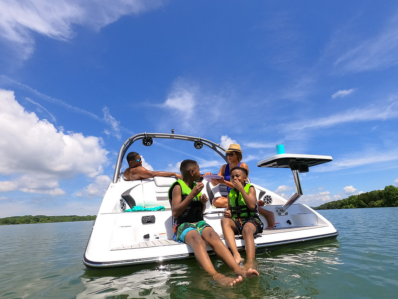 A family on a boat enjoying a day out in the sun.