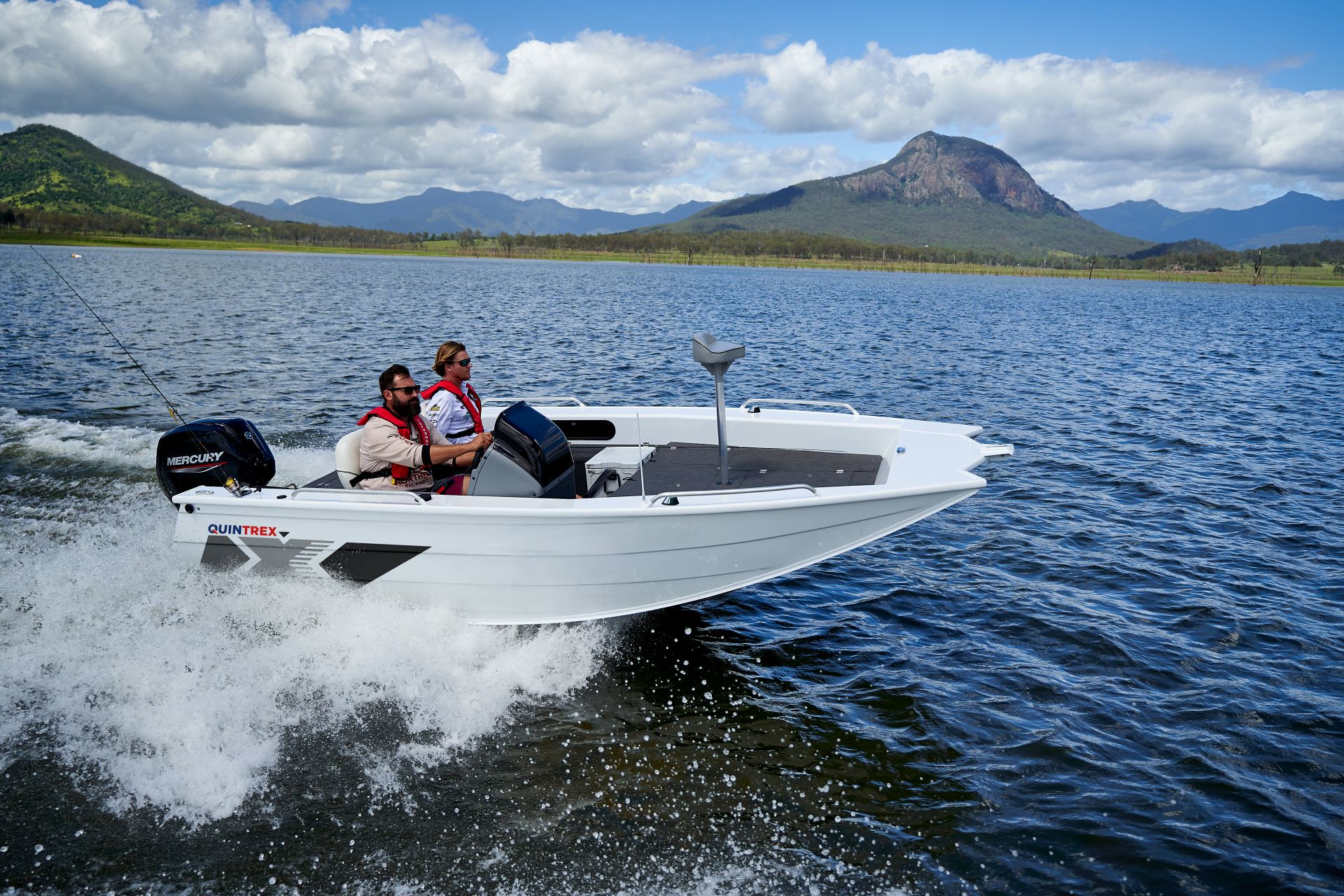 A Quintrex rear console boat navigating on a lake.