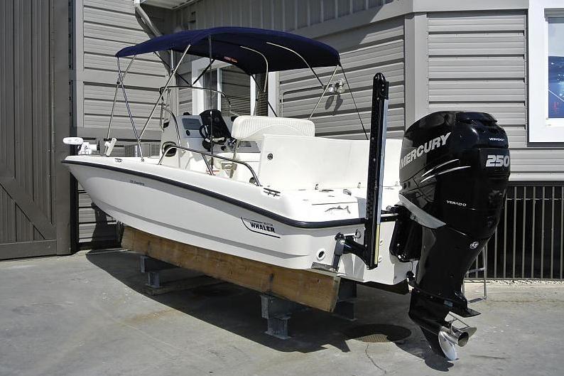 A boat parked behind a garage.