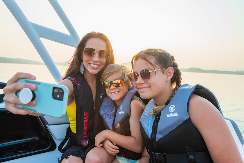 A woman and kids taking a selfie together.