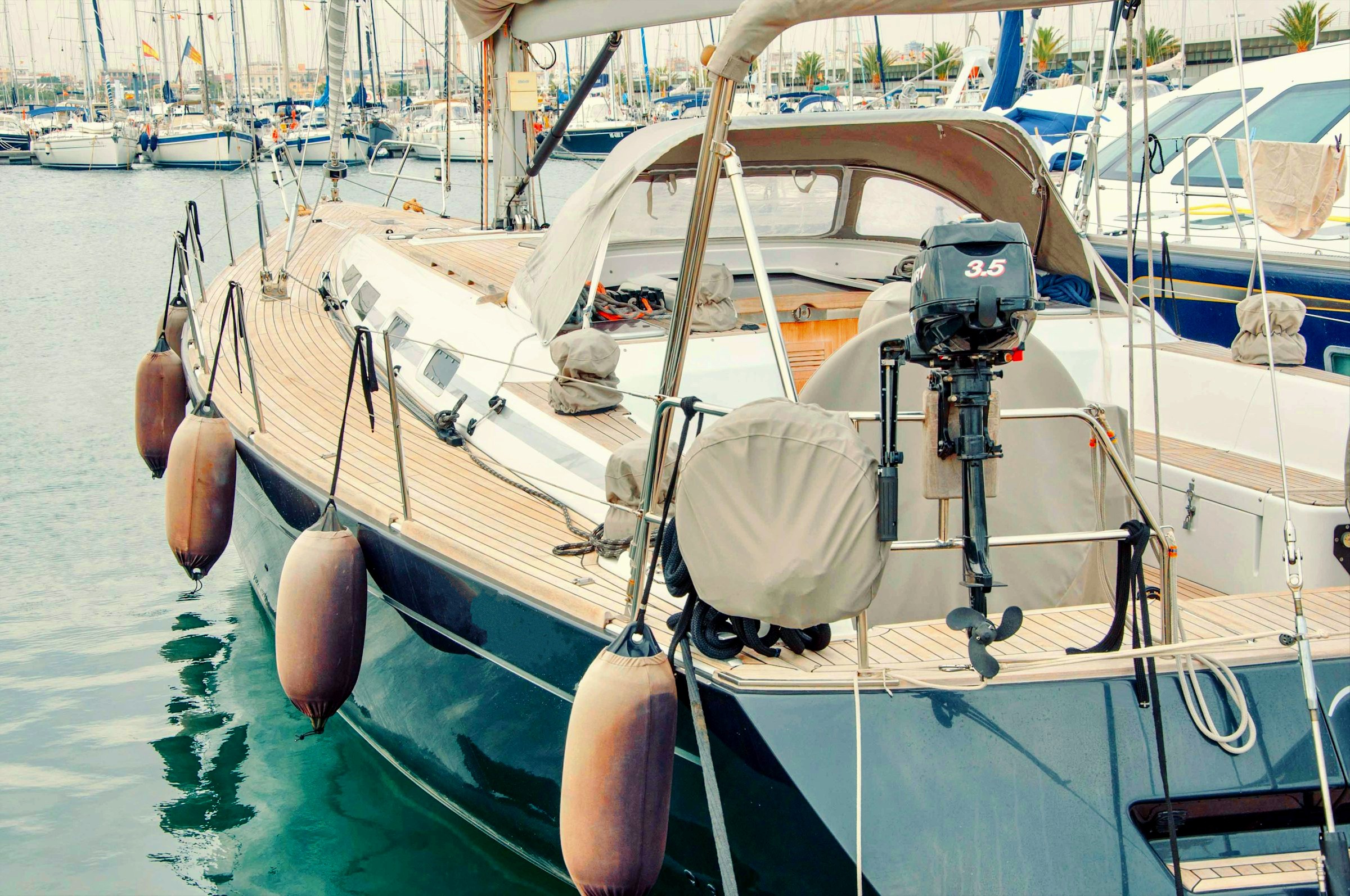 cylindrical fenders hung on the sides of the boat.