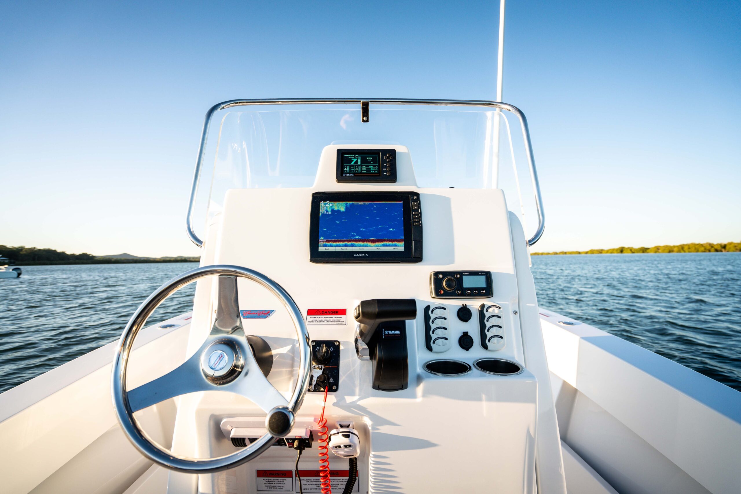 A close up shot of the main console of a white centre console boat.