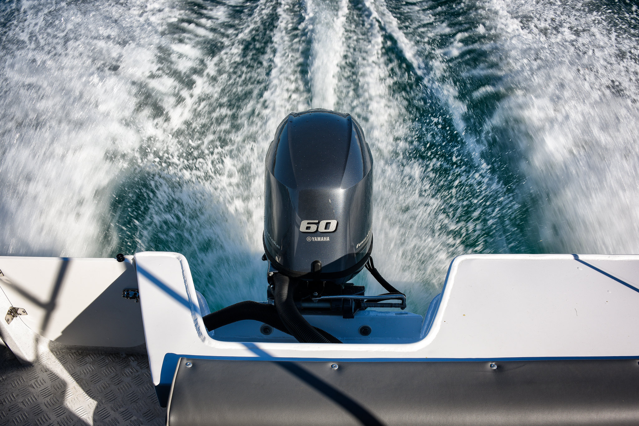 A Yamaha outboard engine running at full speed on the water.