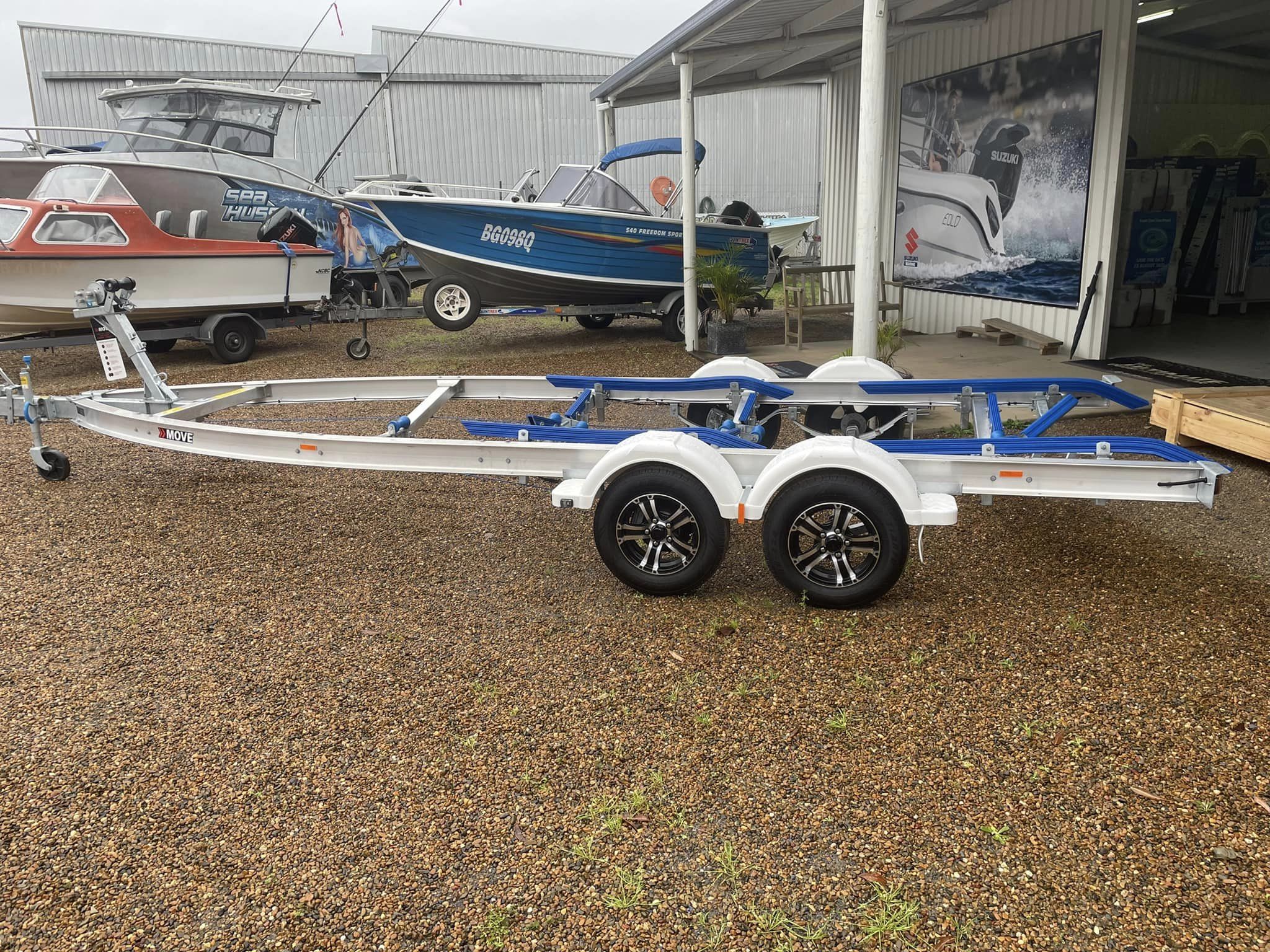 A Move Boat trailer parked in a dealership.