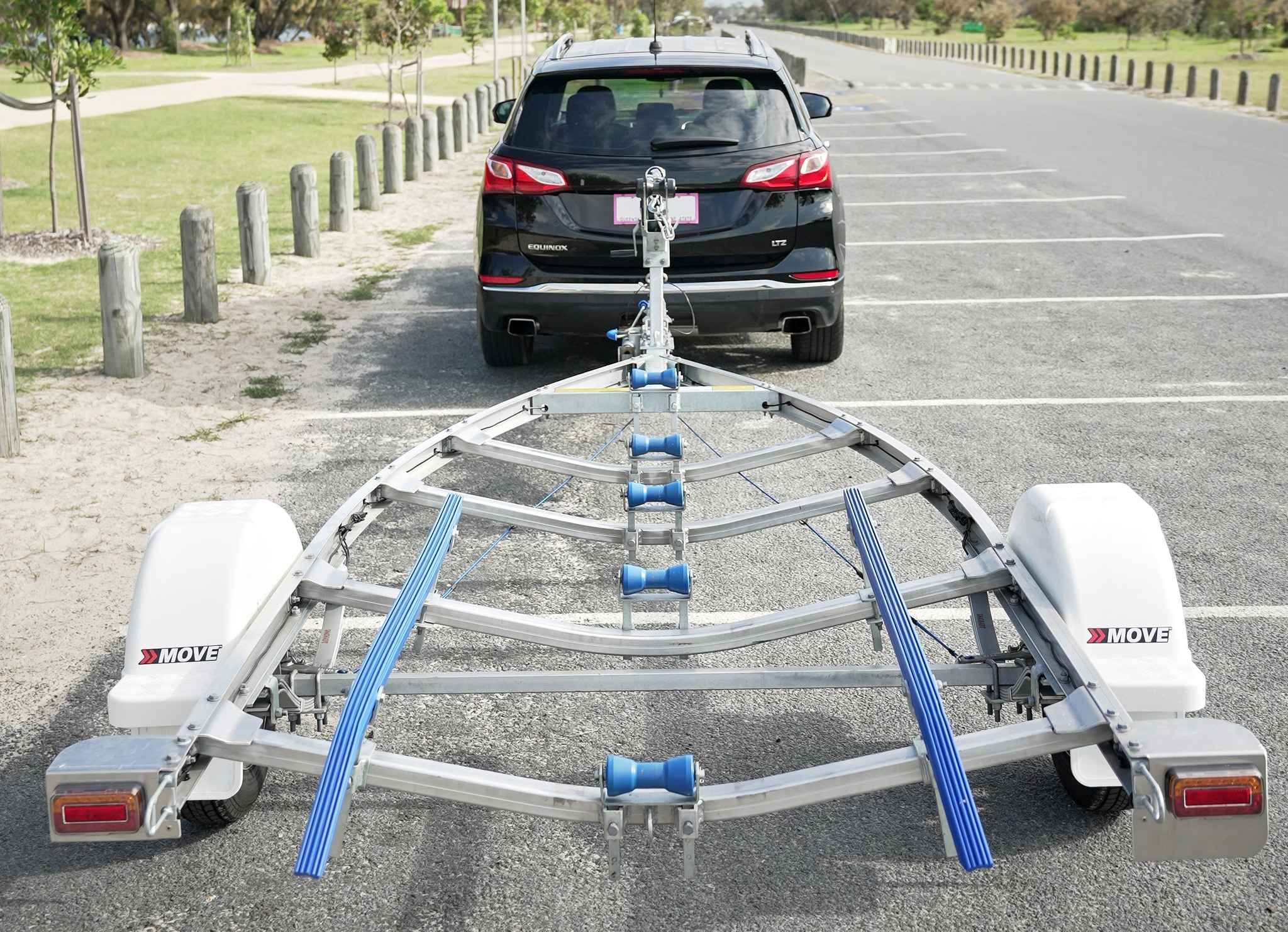 An aluminium boat trailer by Move Boat being towed behind a vehicle.