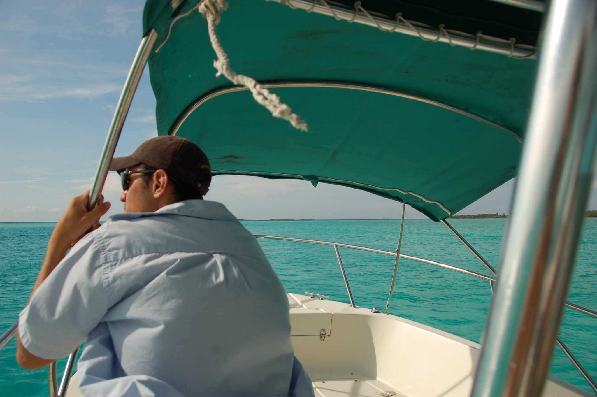 man on a boat with a bimini top