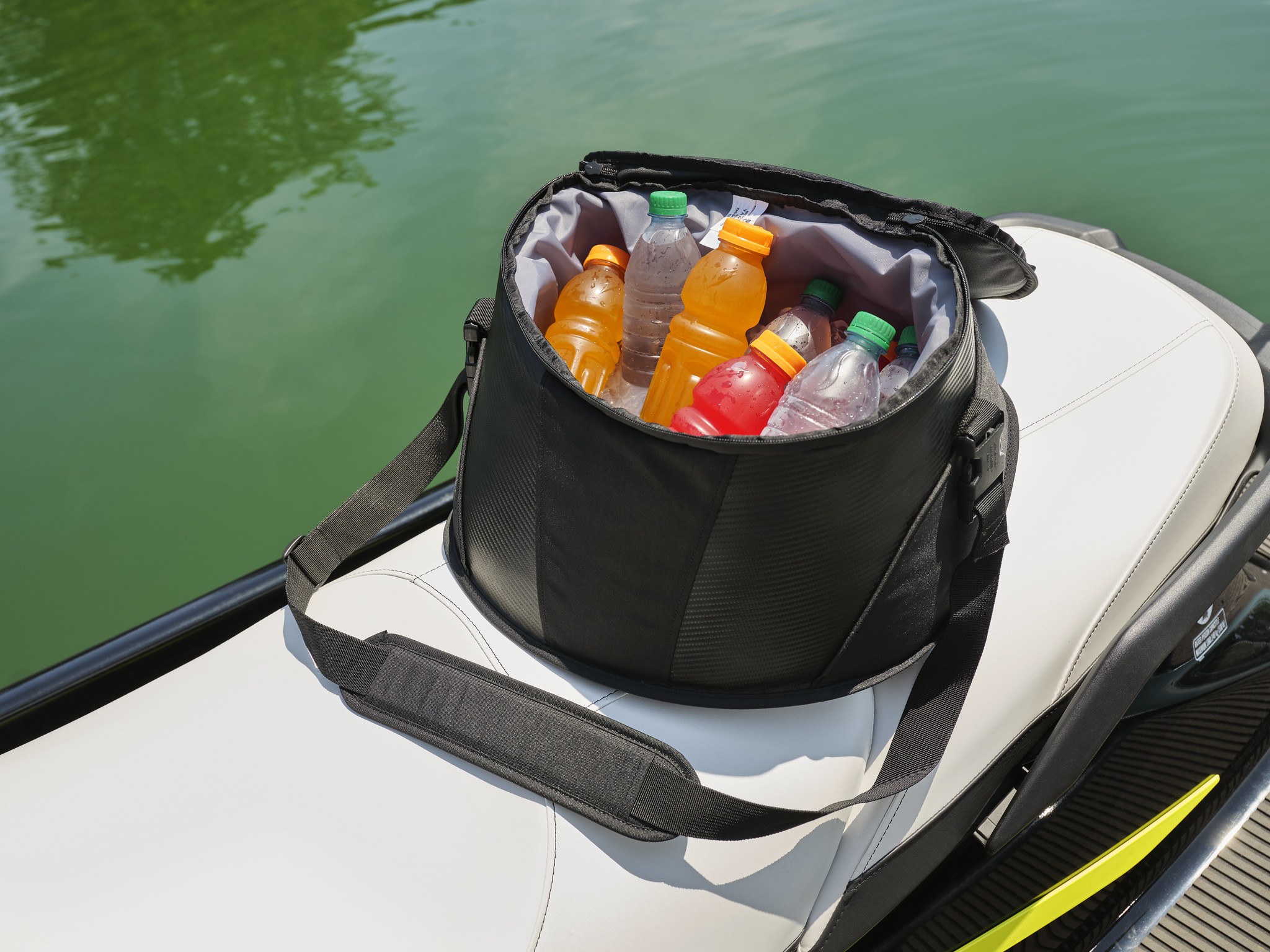 A portable cooler bag full of bottled drinks.