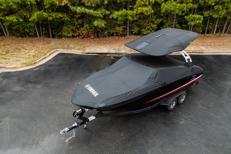 A boat with a hard top is covered in boat cover.