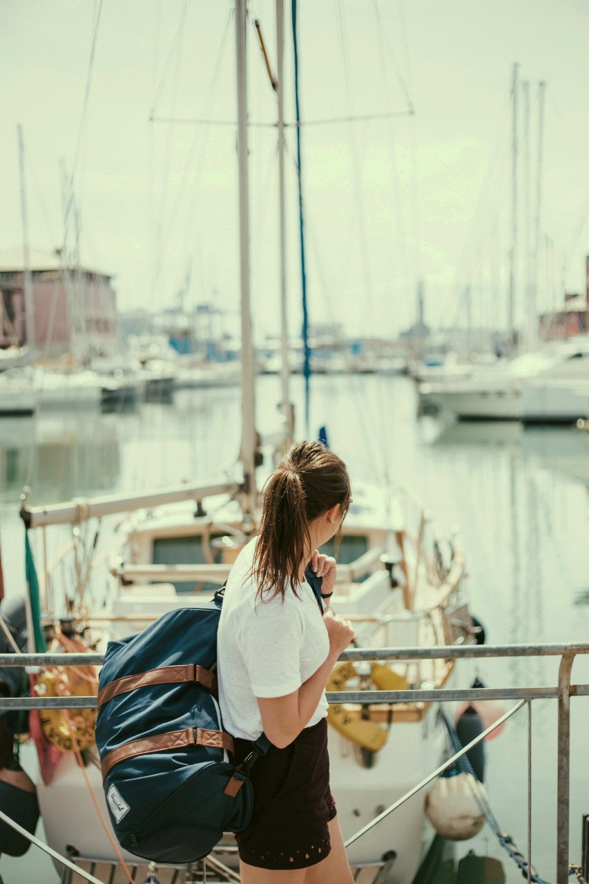 A woman bringing a bag for her boating trip.