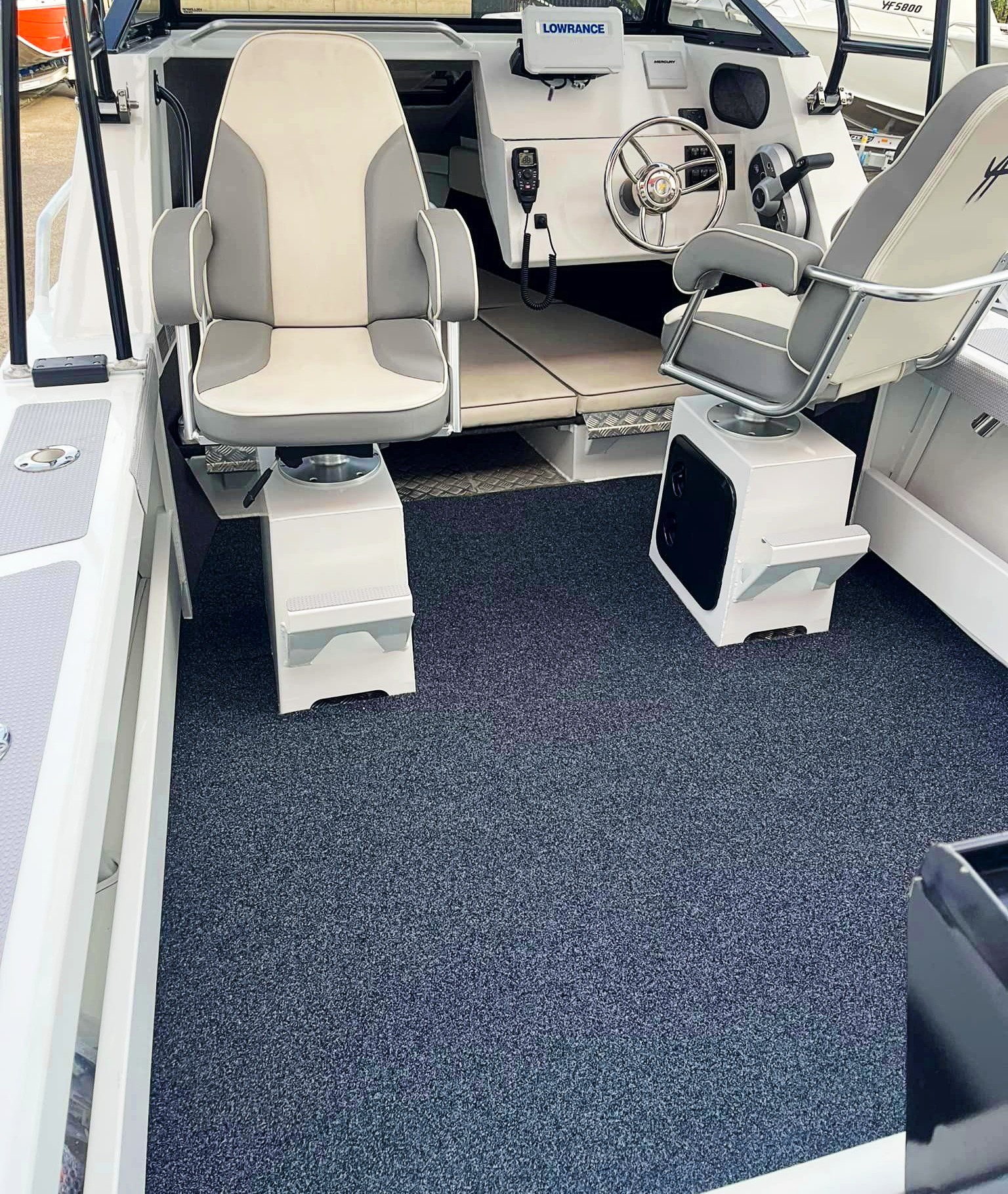 A newly furnished boat carpet on a boat's deck.