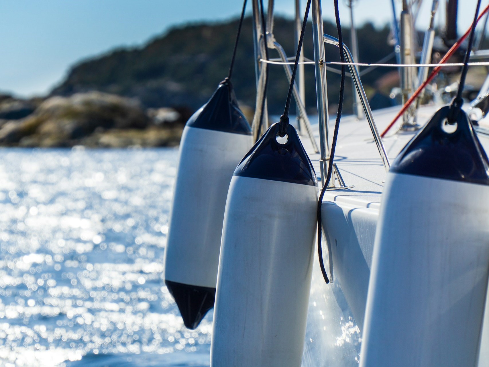 cylindrical fenders hung on the sides of the boat.