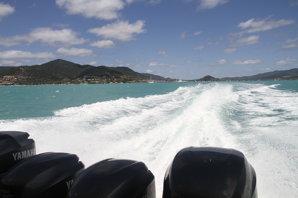 A row of outboard motor engine powering a boat to travel at sea.