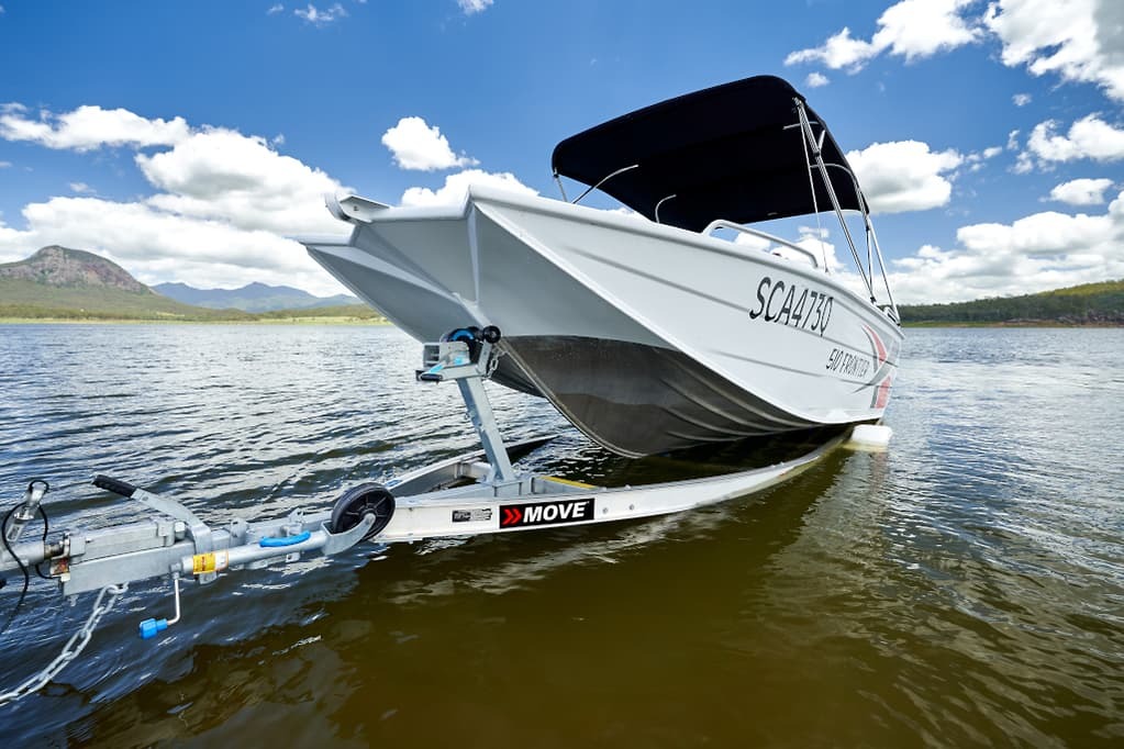 A low angle shot of a boat trailer and a boat.