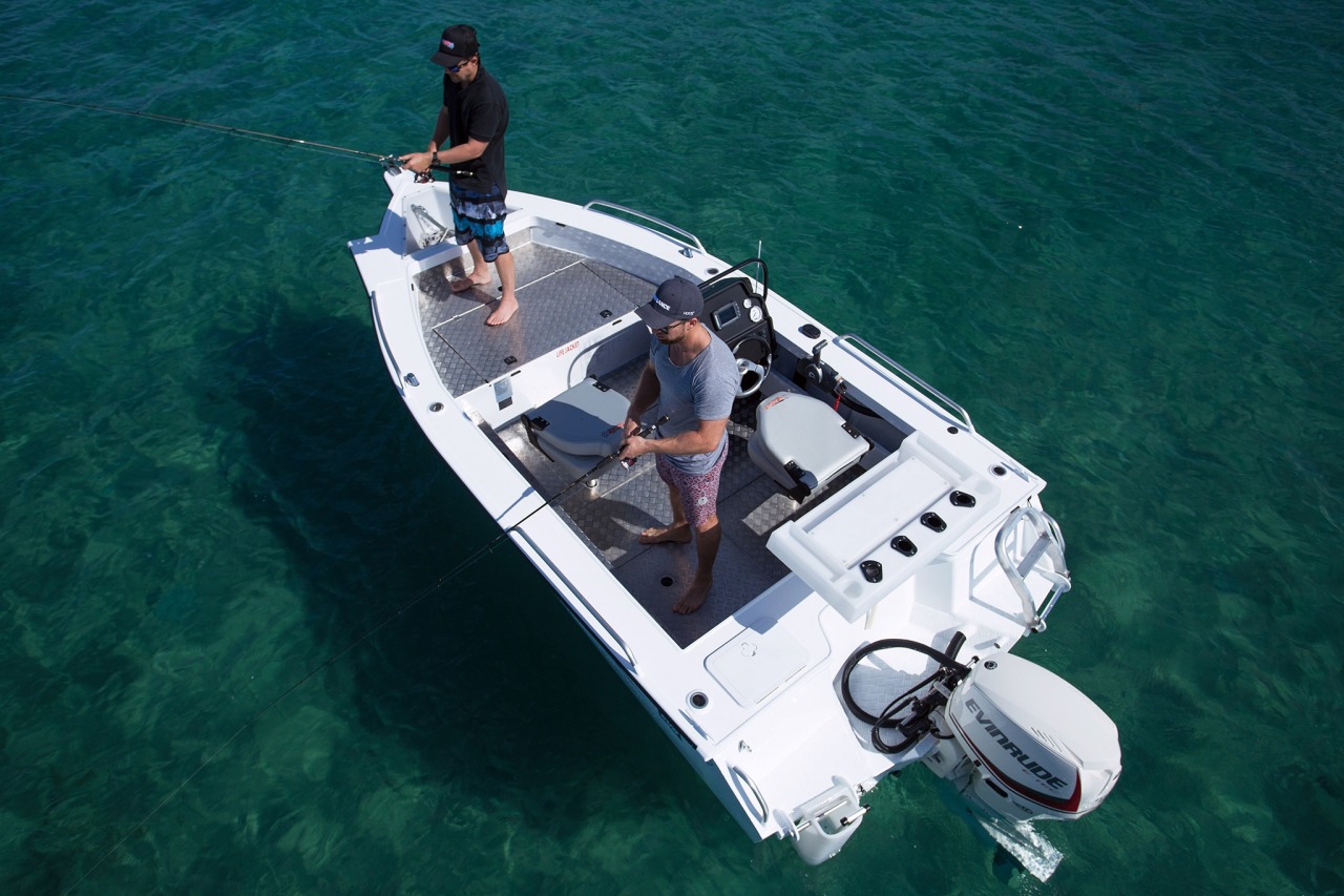 Two fishermen fishing on their boat