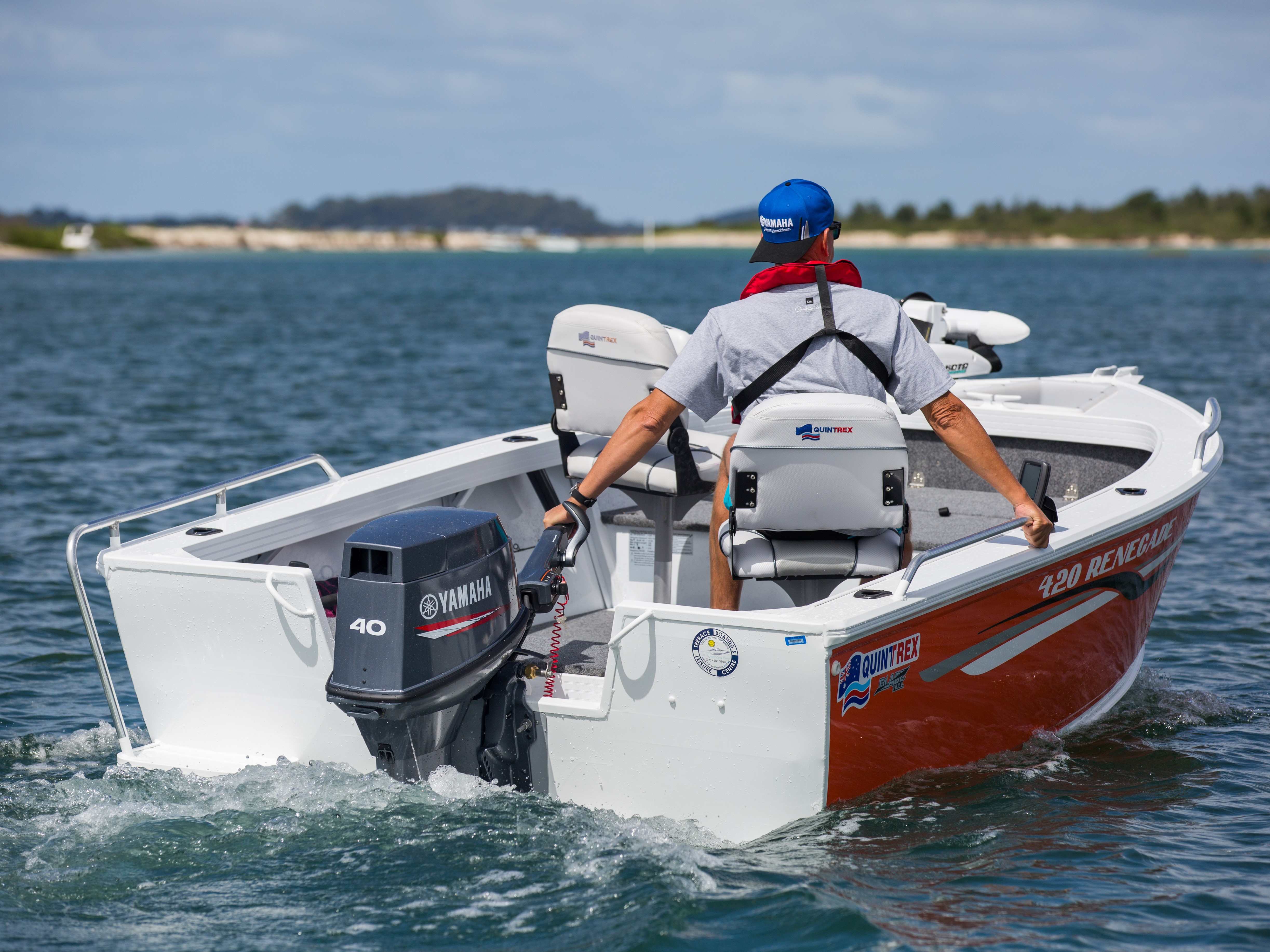 man navigating a quintrex renegade using a tiller outboard motor