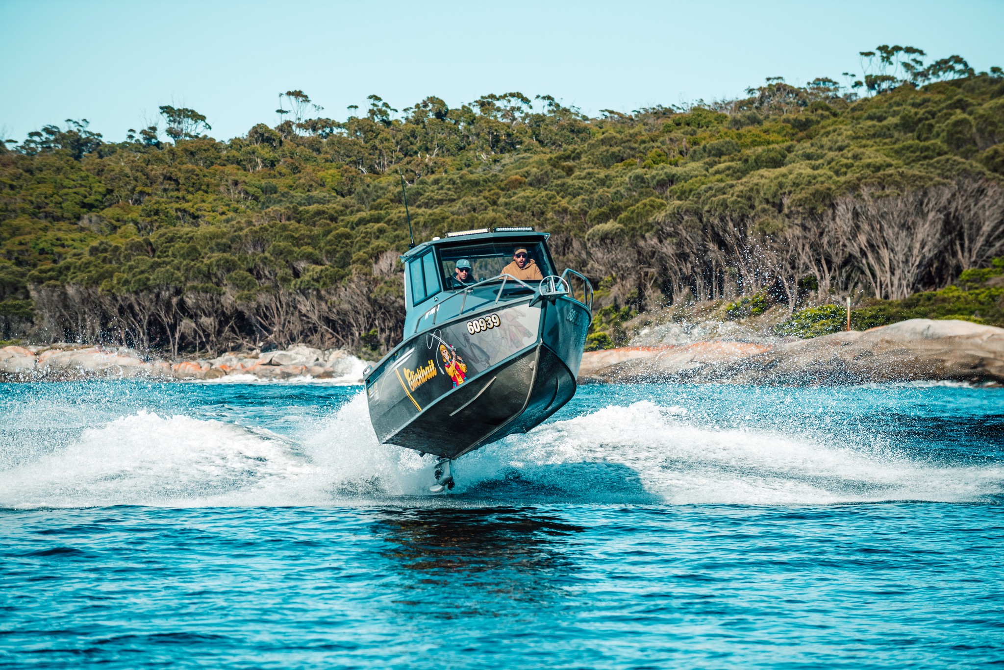 A Yellowfin boat trimming over a body of water.