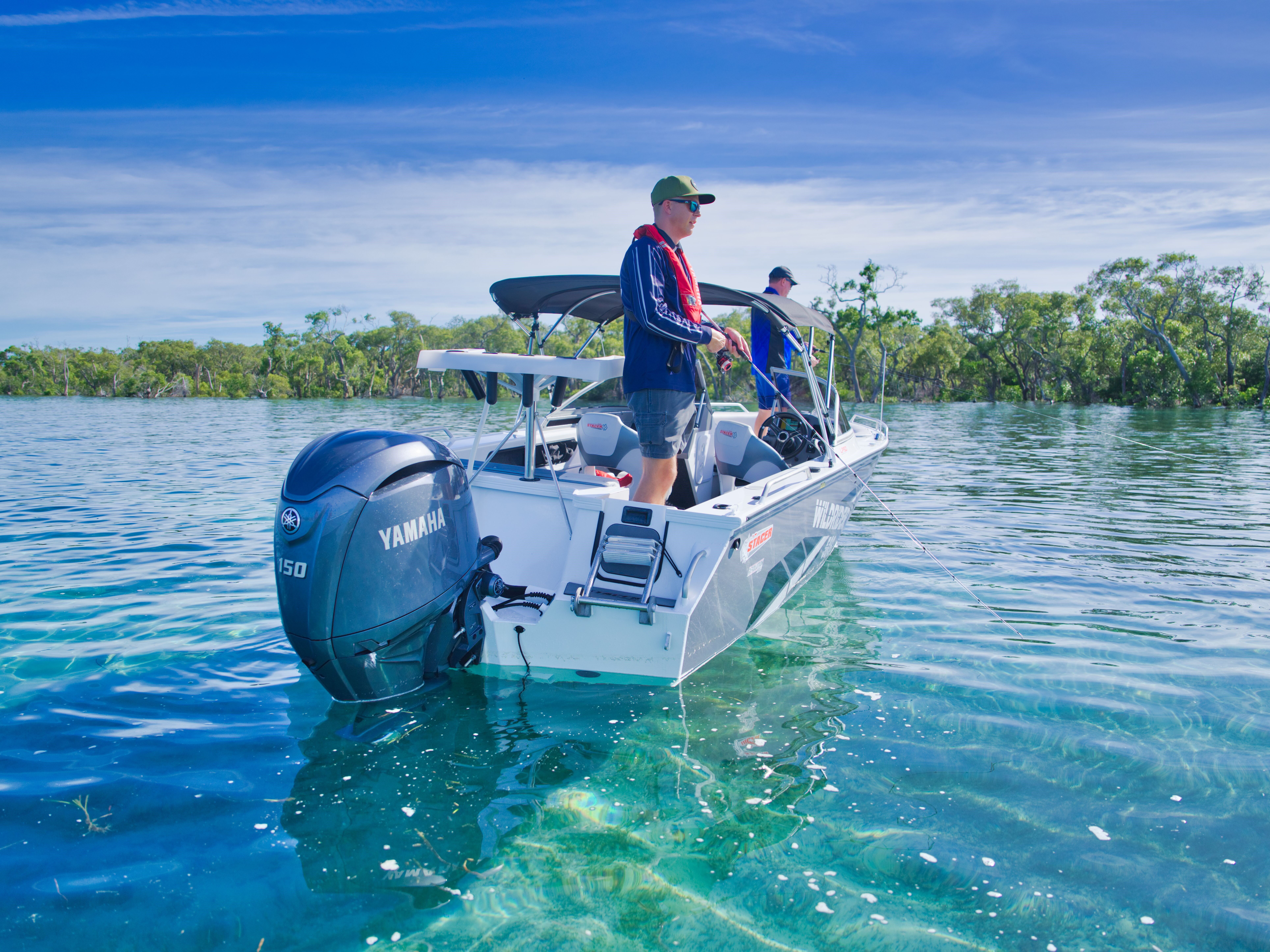 A pair of men fishing on a Stacer boat