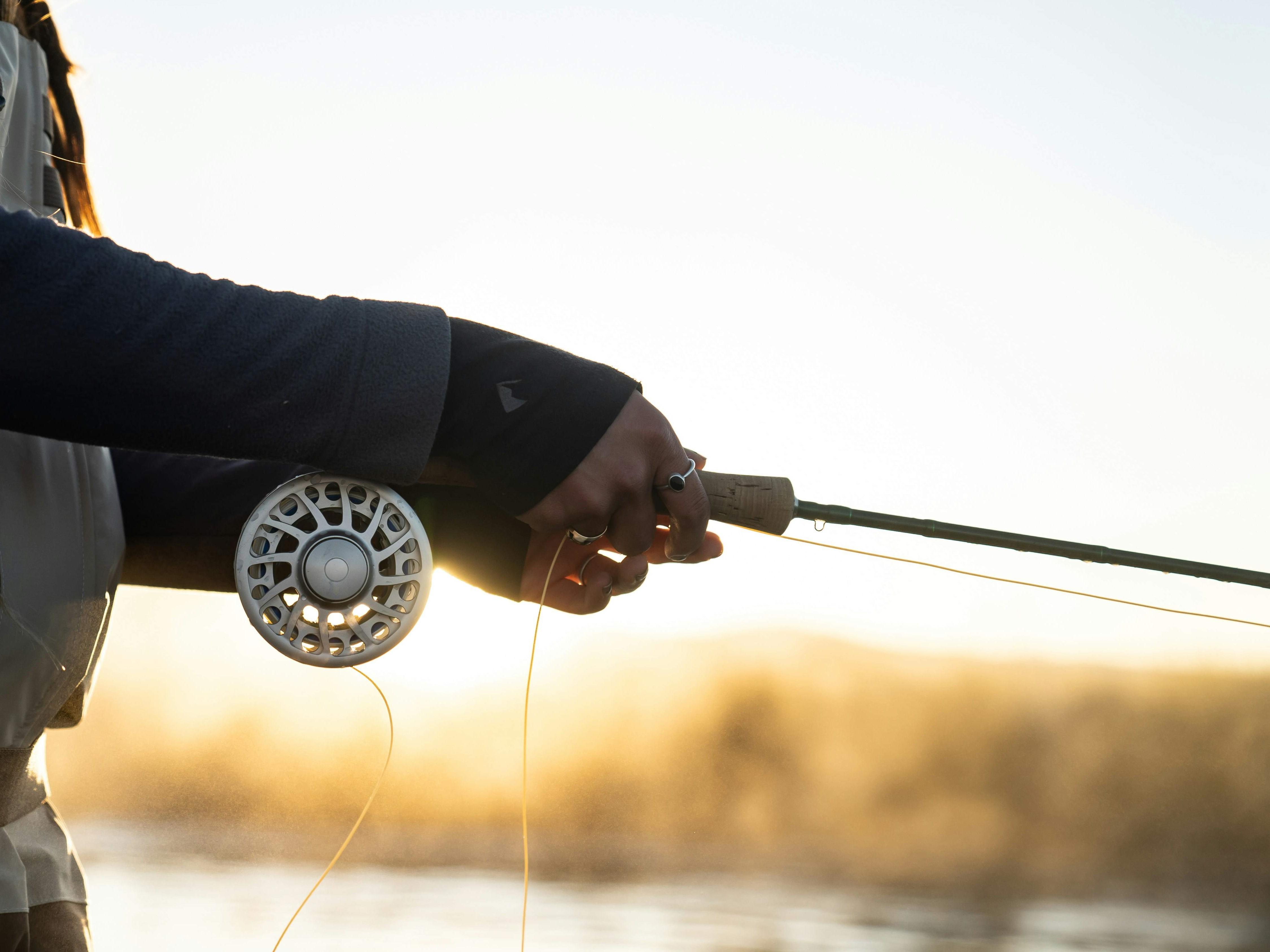 A person holding a fishing rod.