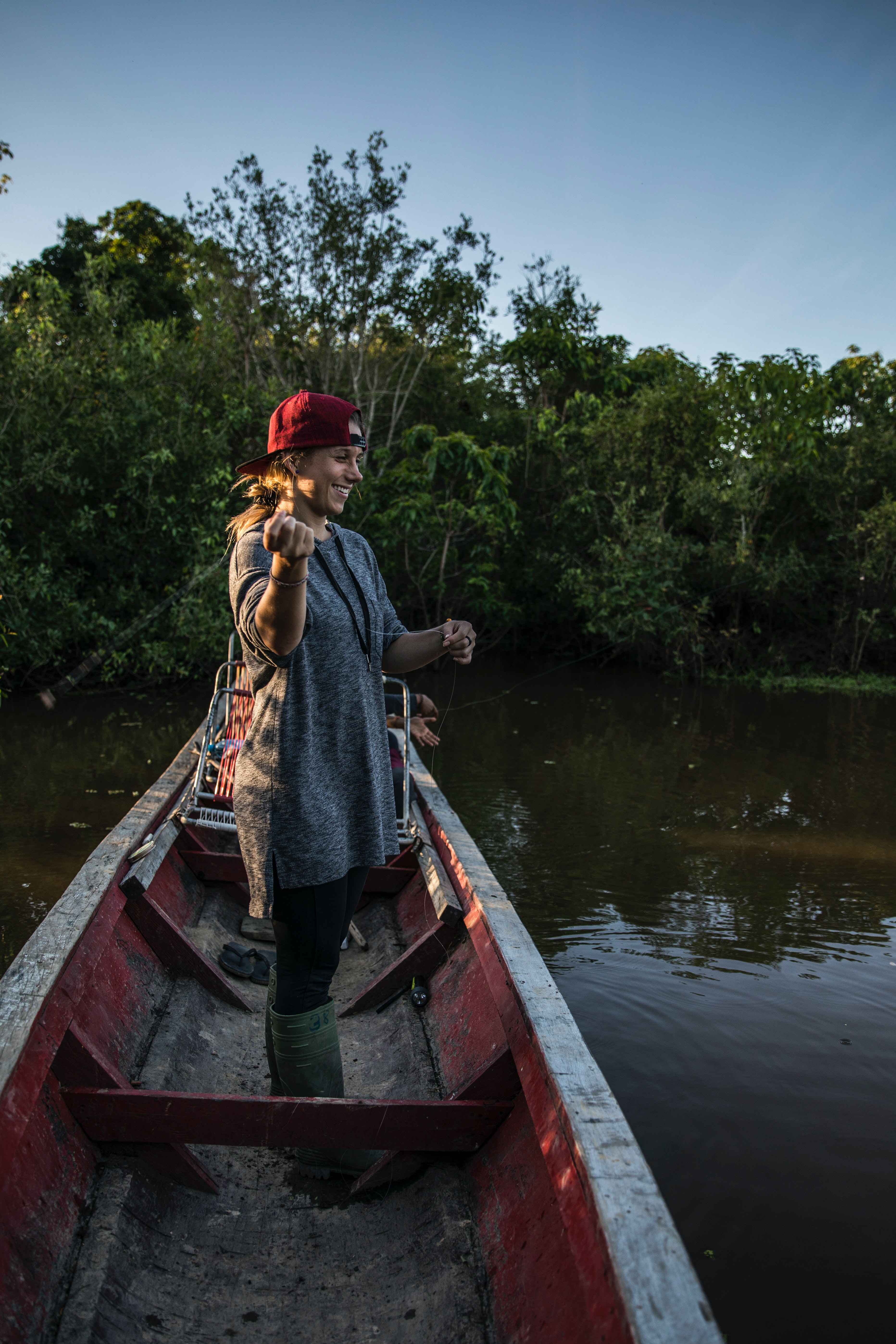 A woman angler fishing on a boat.