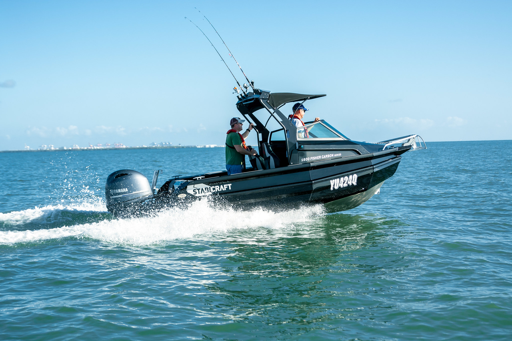 A Stabicraft fishing boat with a Yamaha outboard operated by two men out in the water.