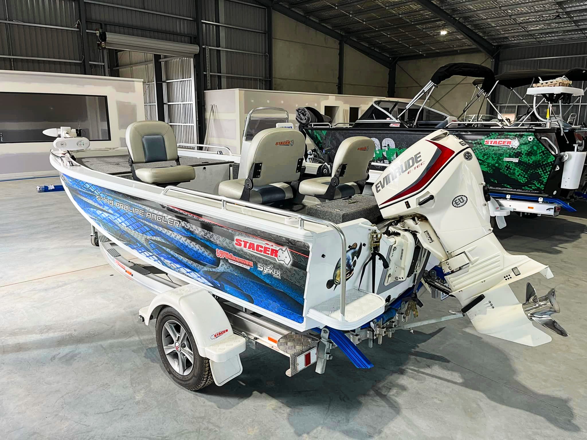 Stacer boats displayed inside a dealership.