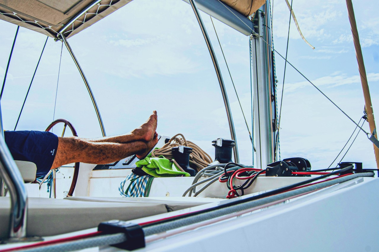 Person propping his feet on a boat.