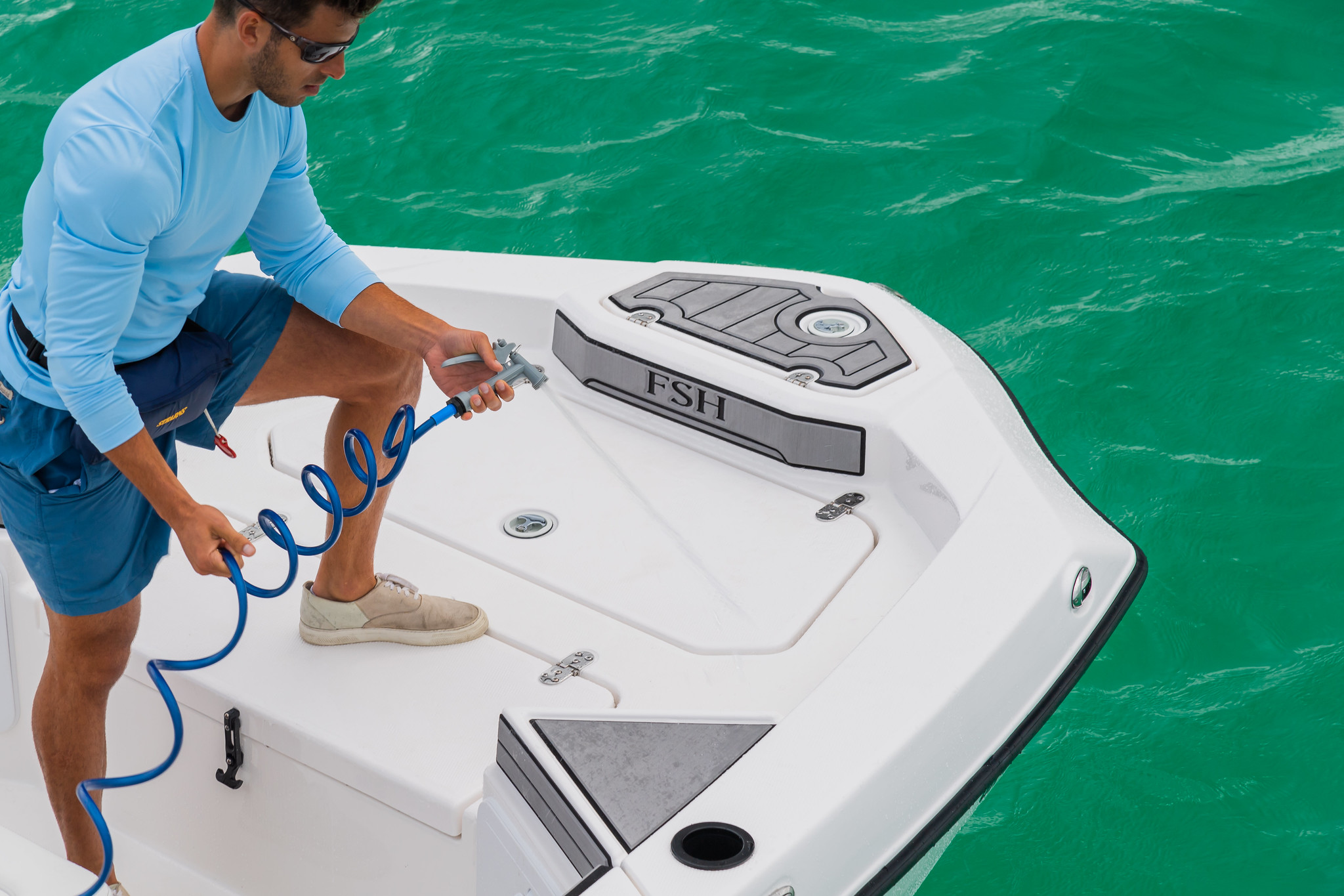 man cleaning a the interior of a boat onboard