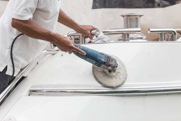 A man buffing a boat's hull.