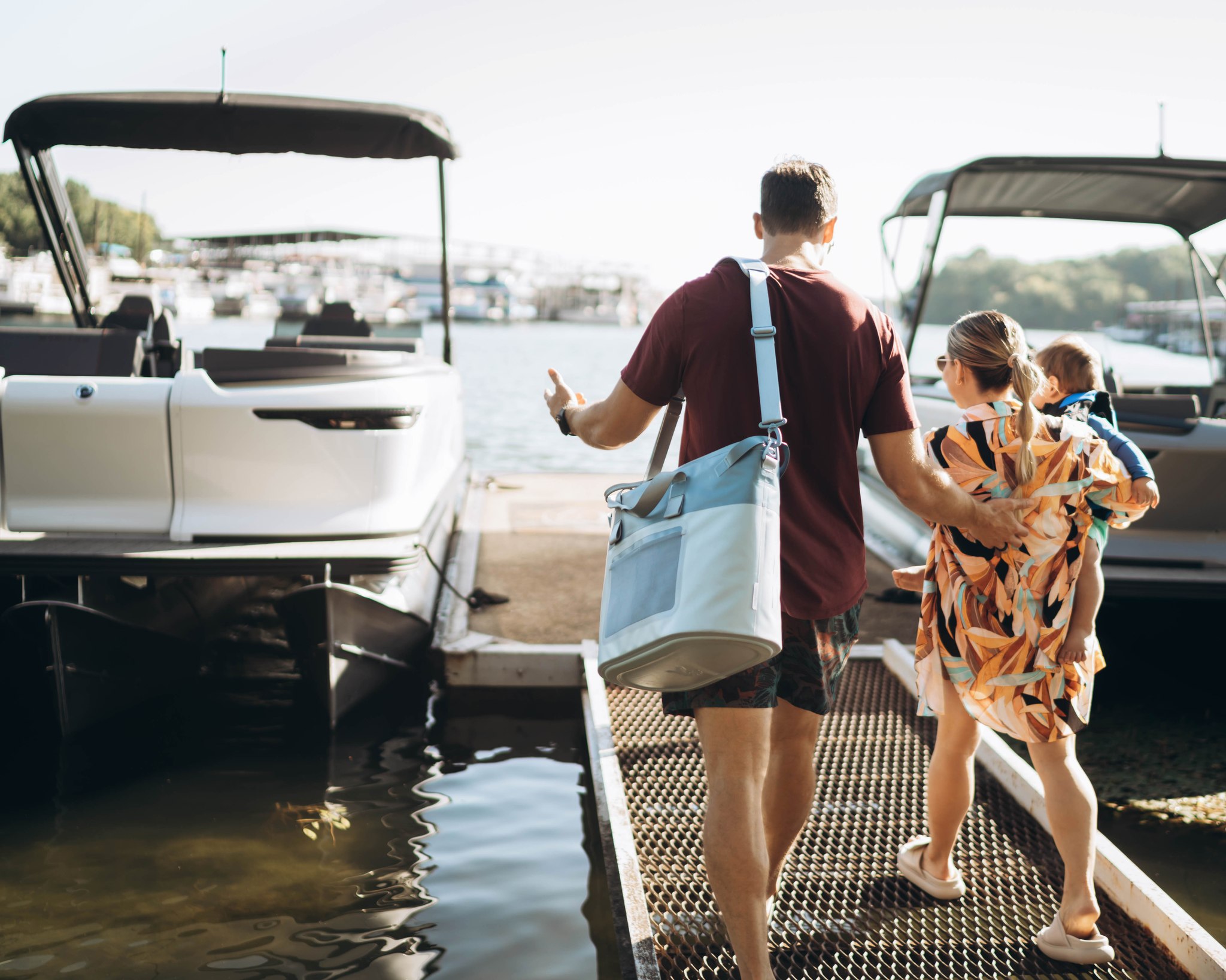 A family on a pontoon on their way to board on a pontoon boat.