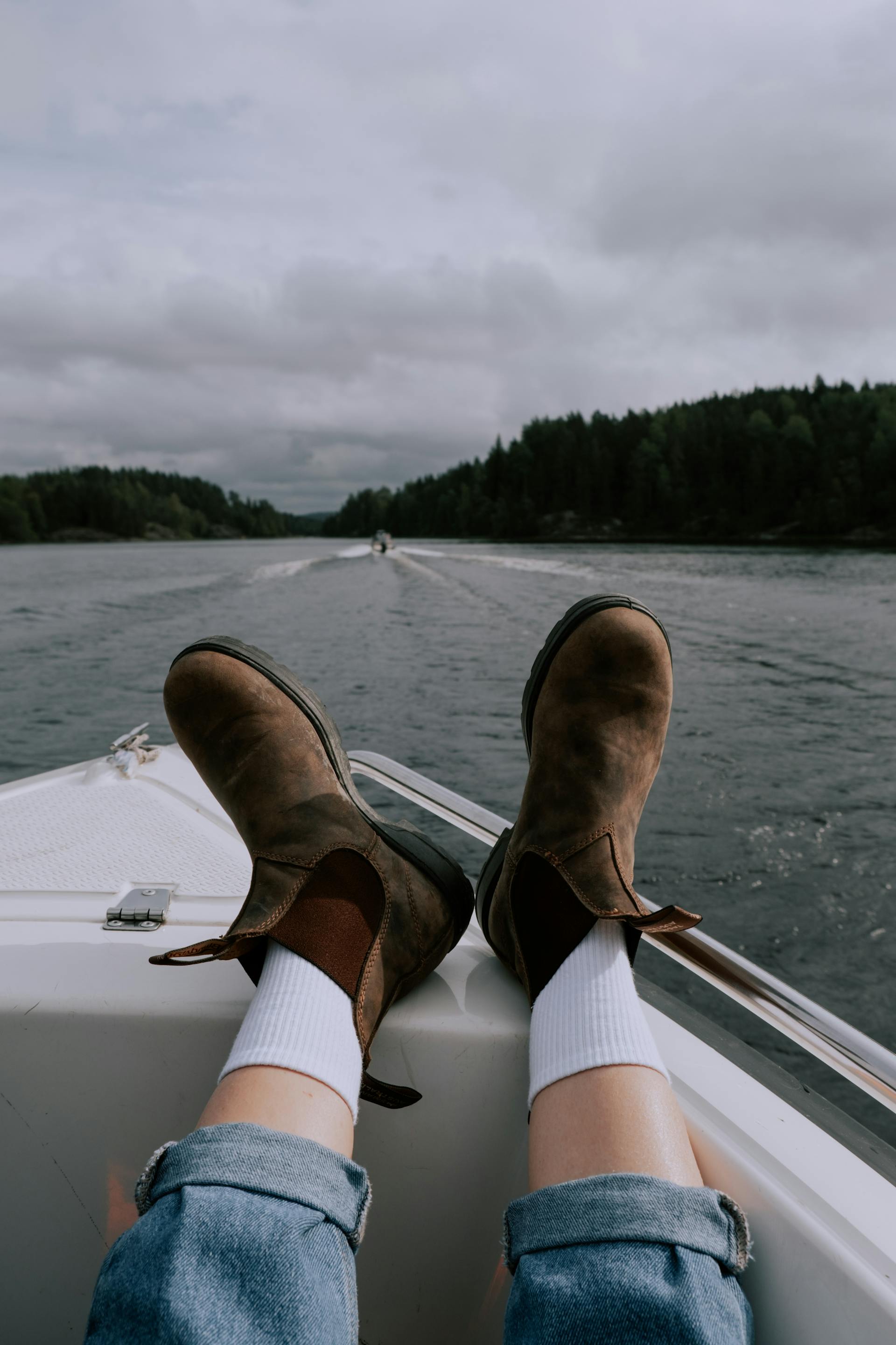 Pair of feet propped up on a boat.