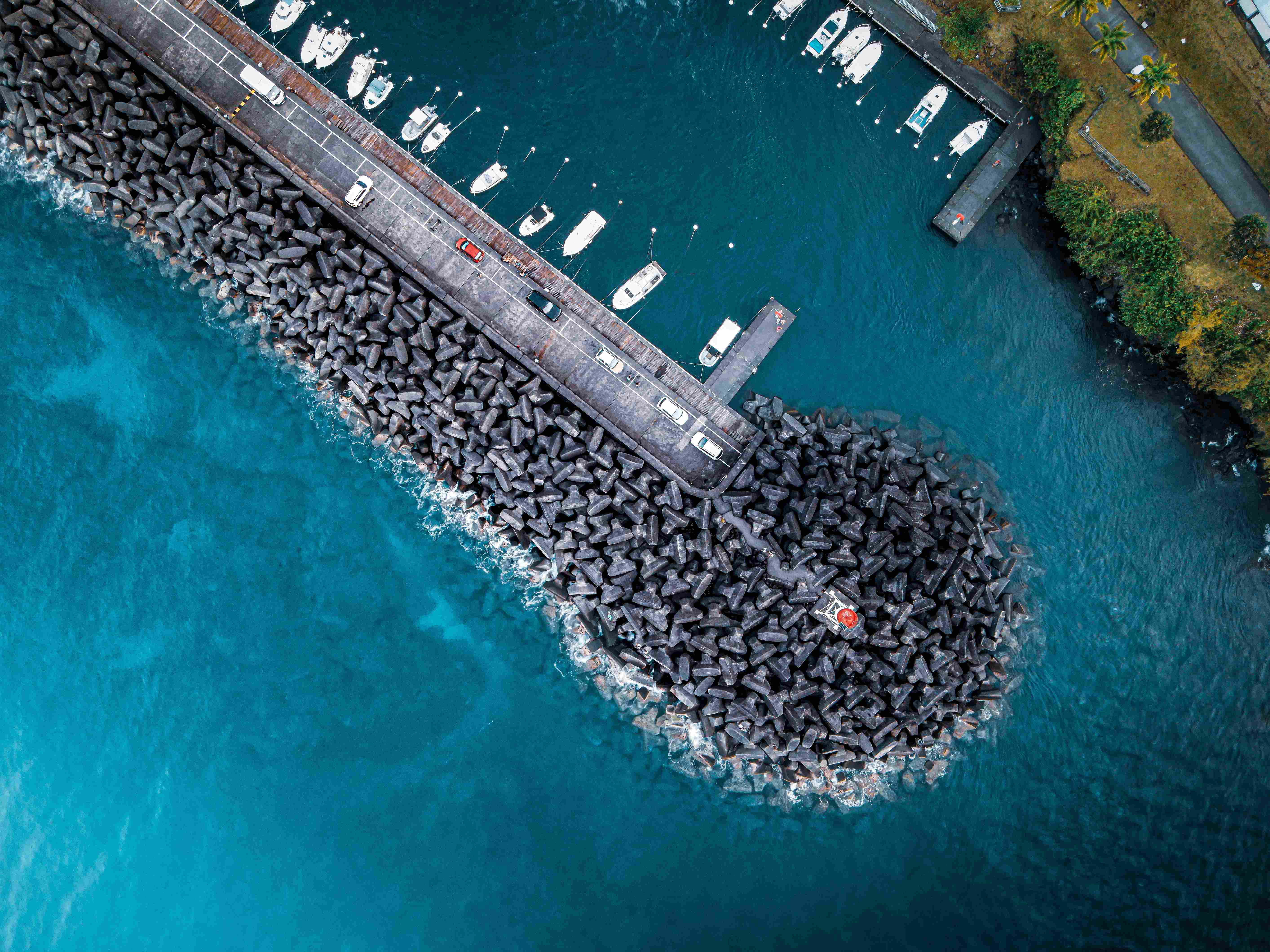 A birds eye view of boats docked at the coast.