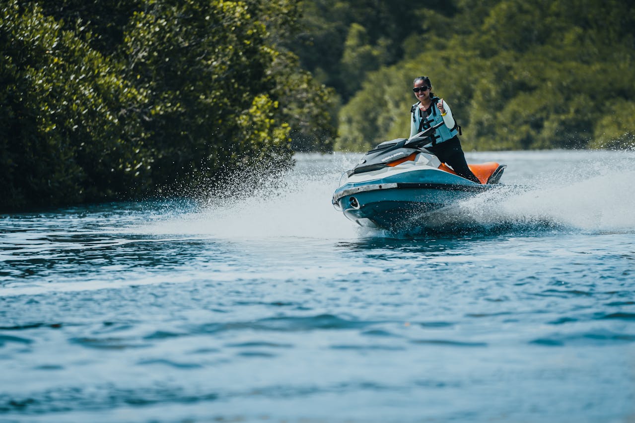 A woman riding a Sea-Doo jet ski.