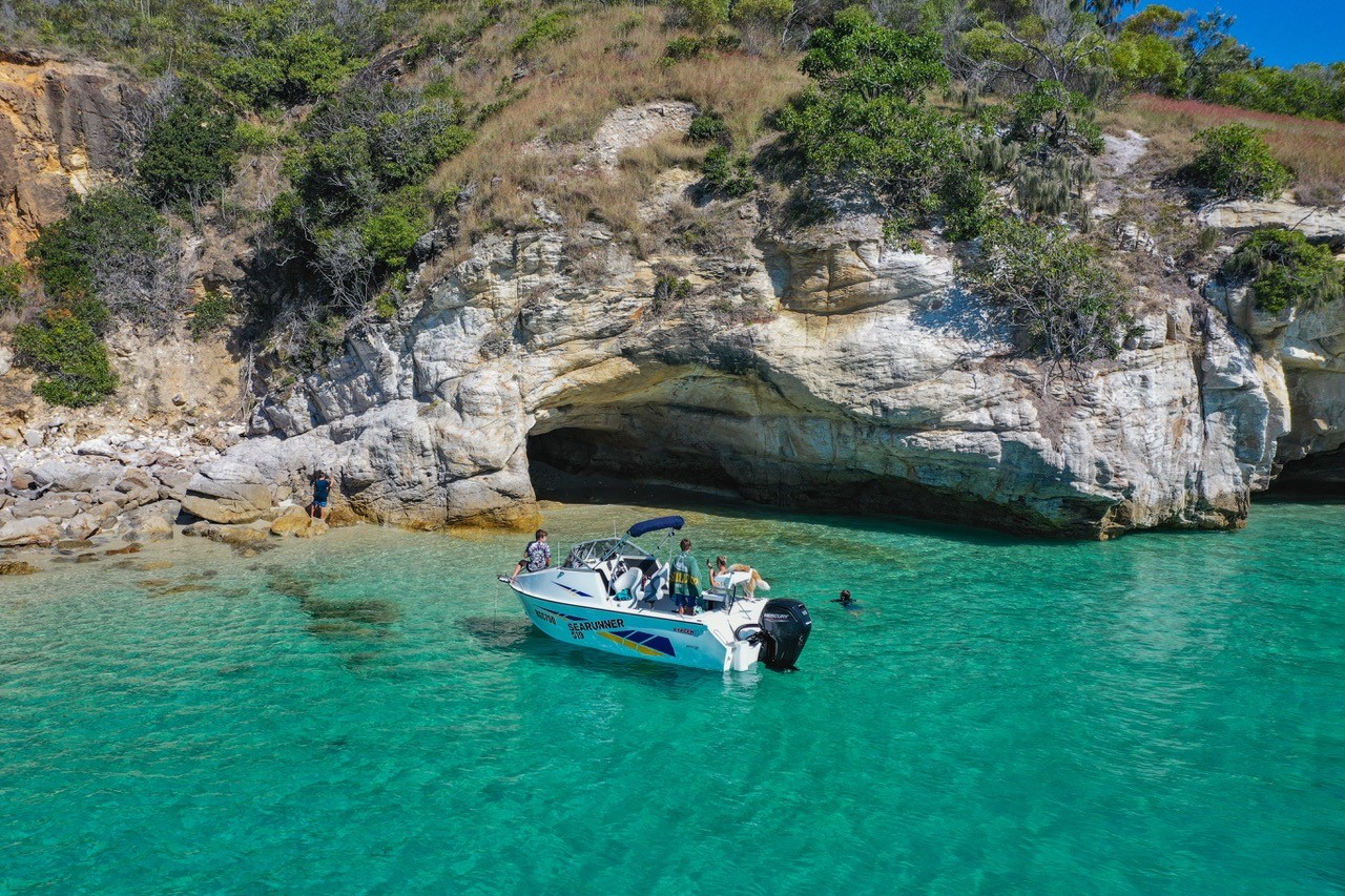 stacer boat moored near a cave