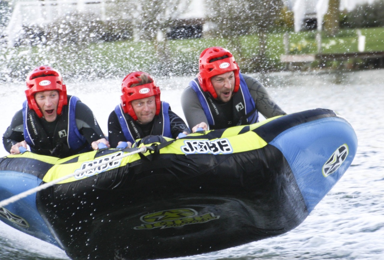 Three men riding a tube.