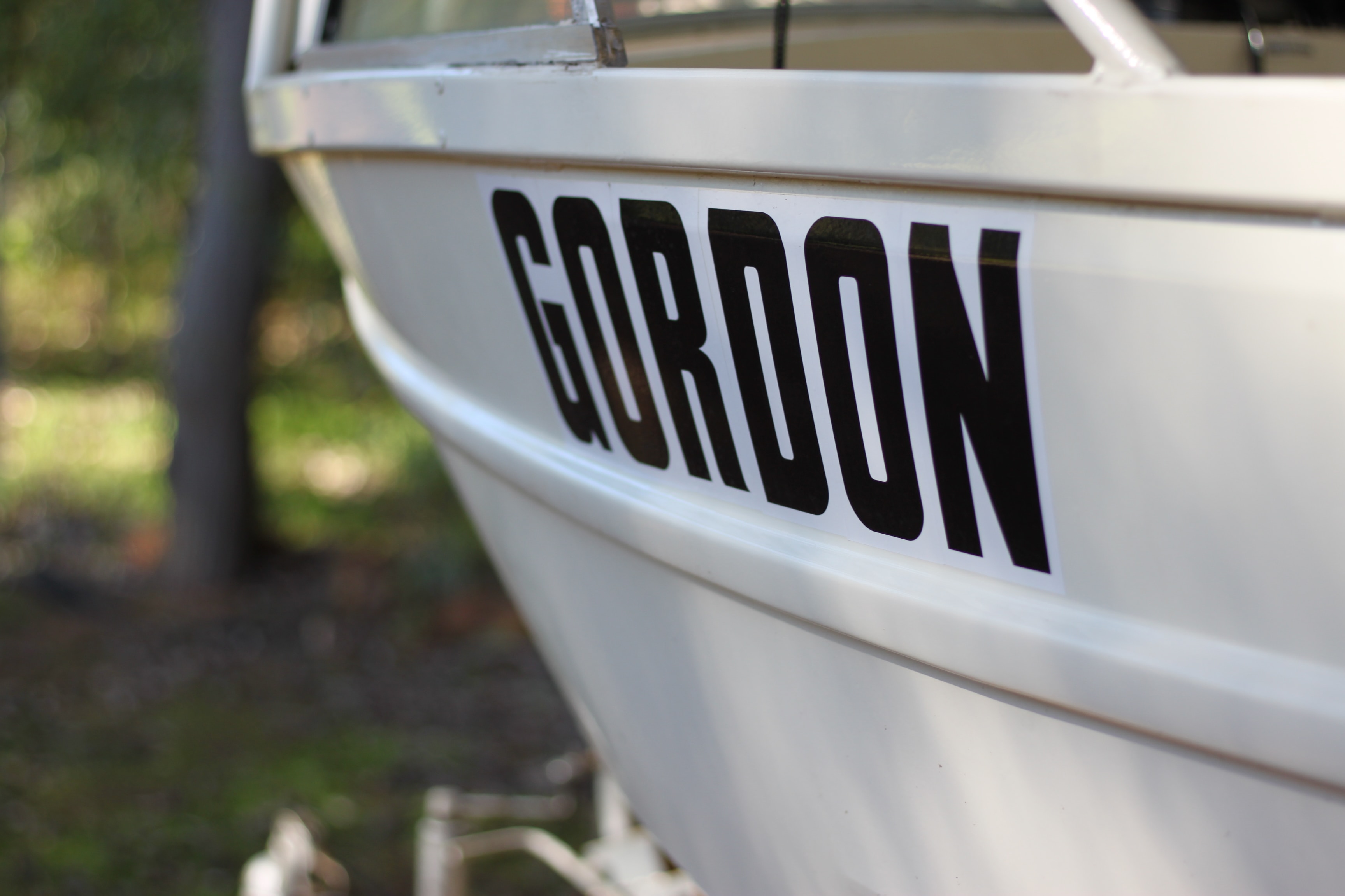 White boat detailing spells out the name 