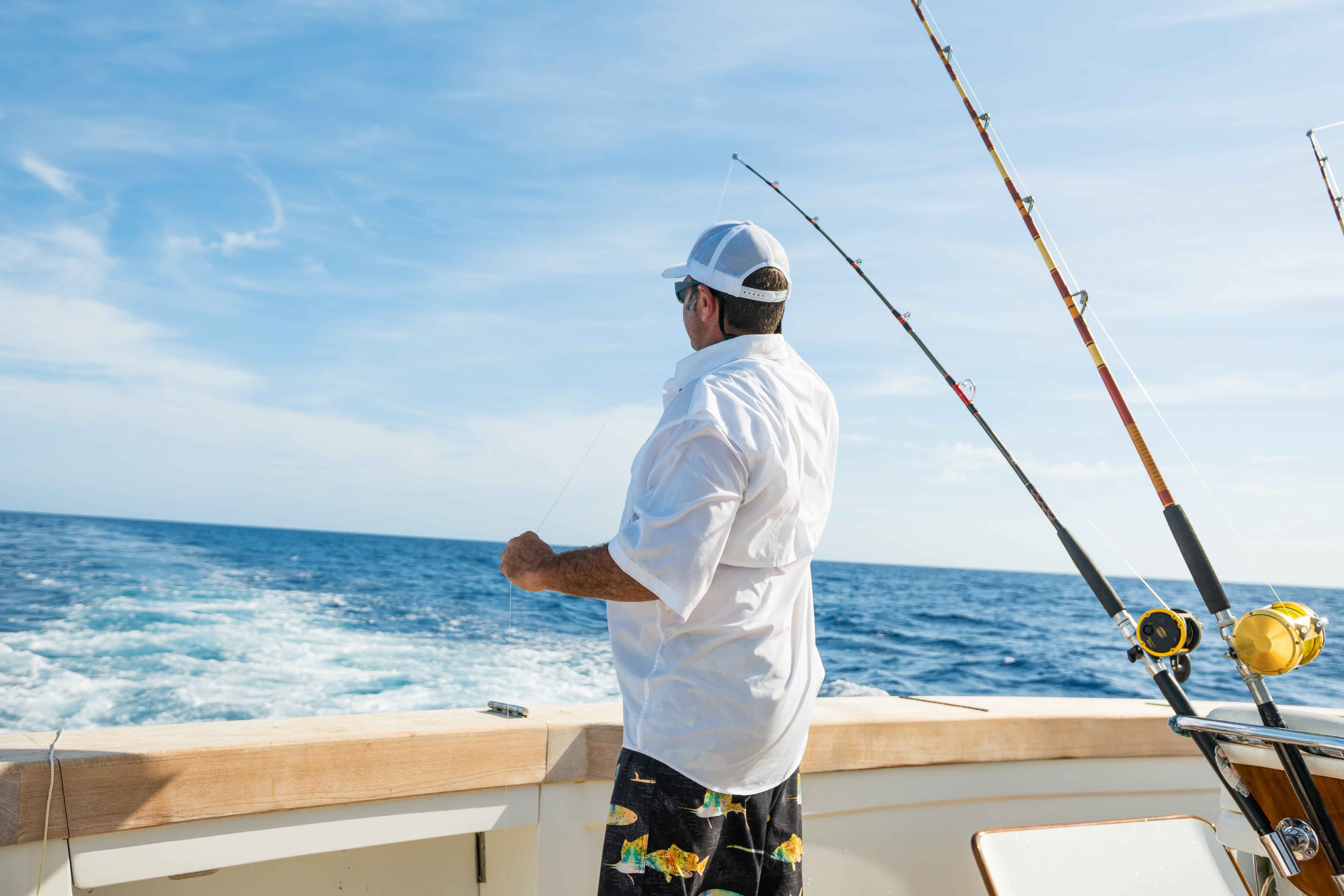 A man looking out on the ocean on a boat.