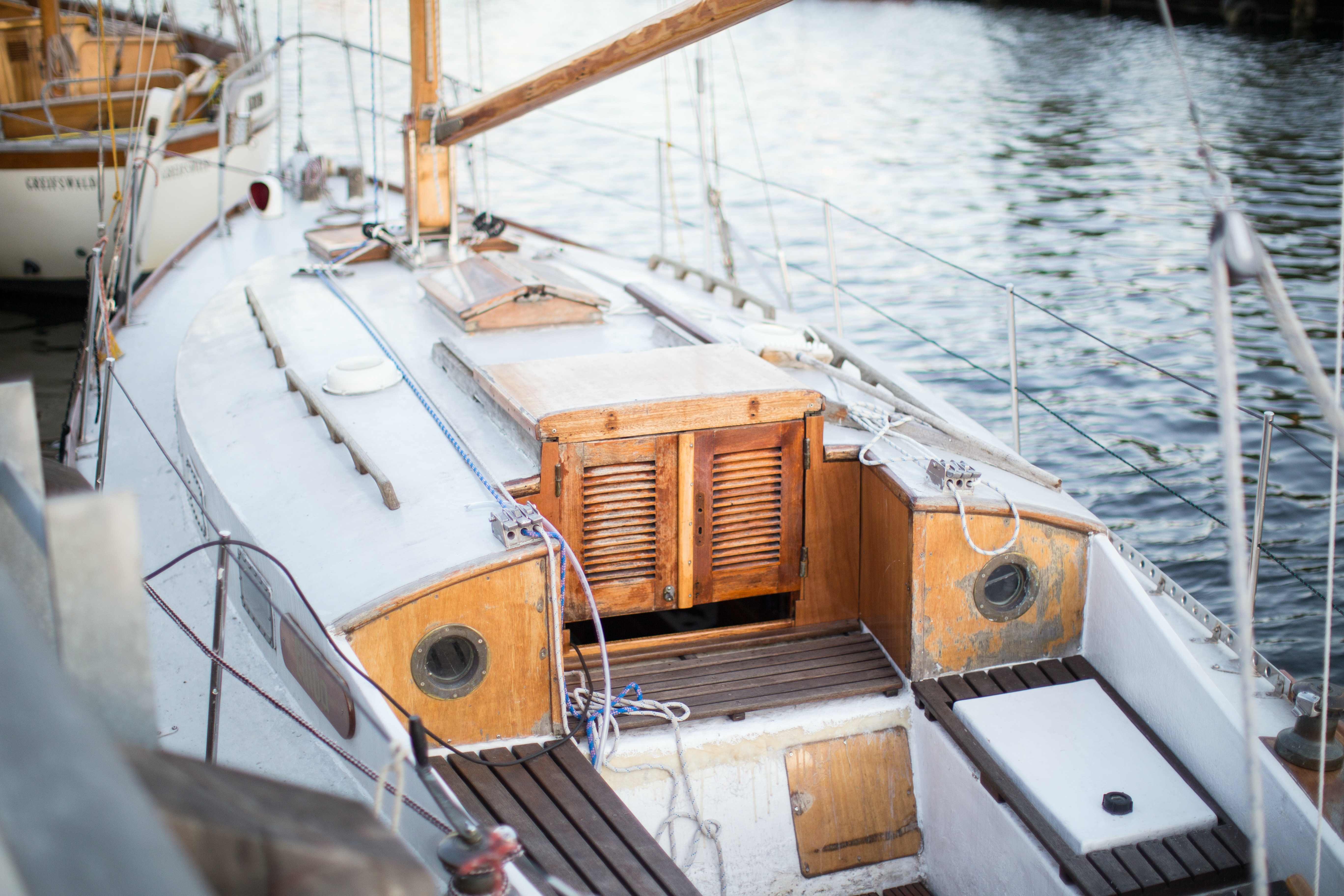 A long shot of a sailing boat's wooden deck with a view of the cabin's door.