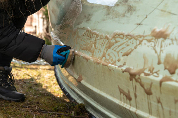 Person cleaning a boat's hull