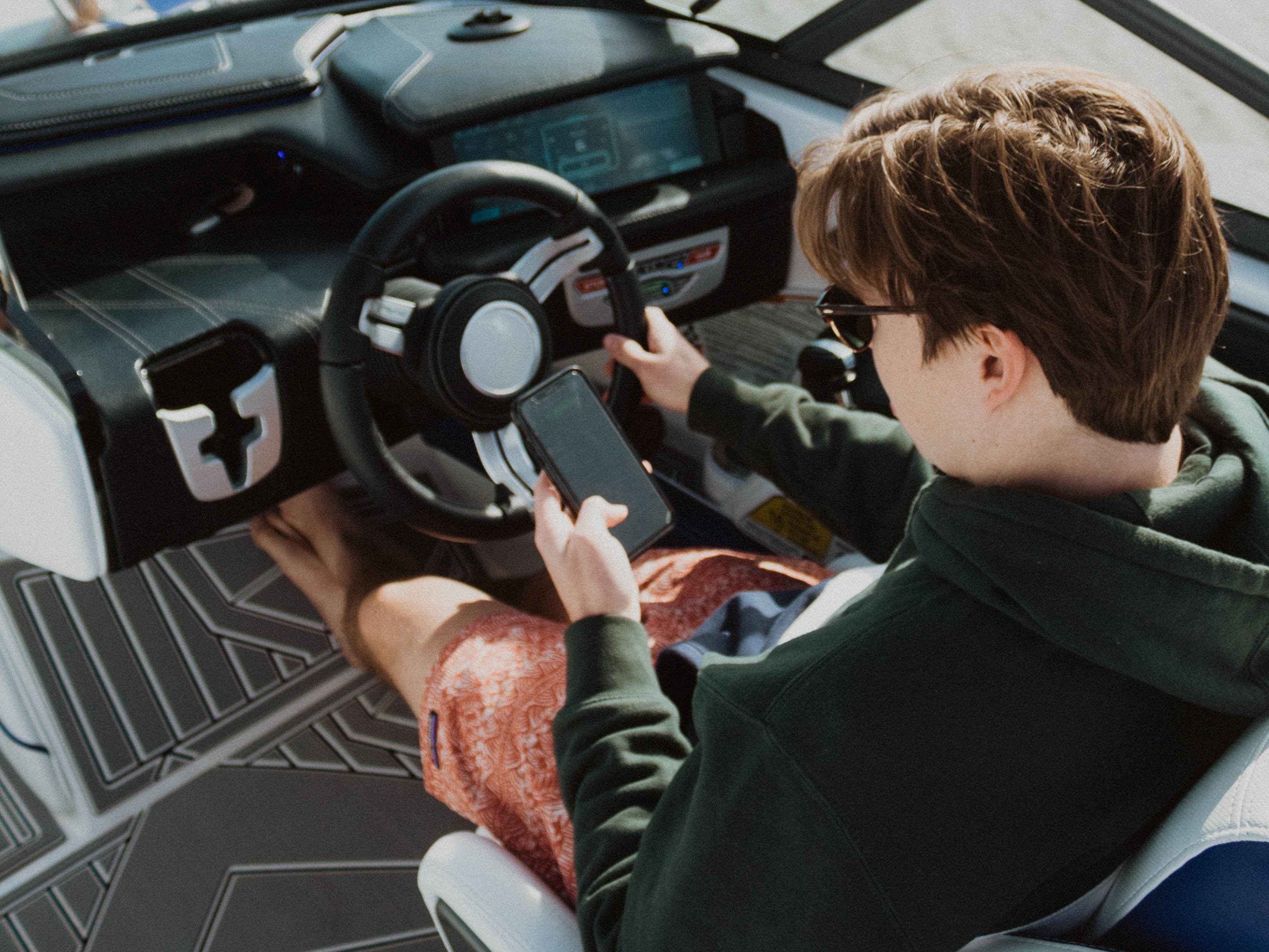 Man operating a boat console.