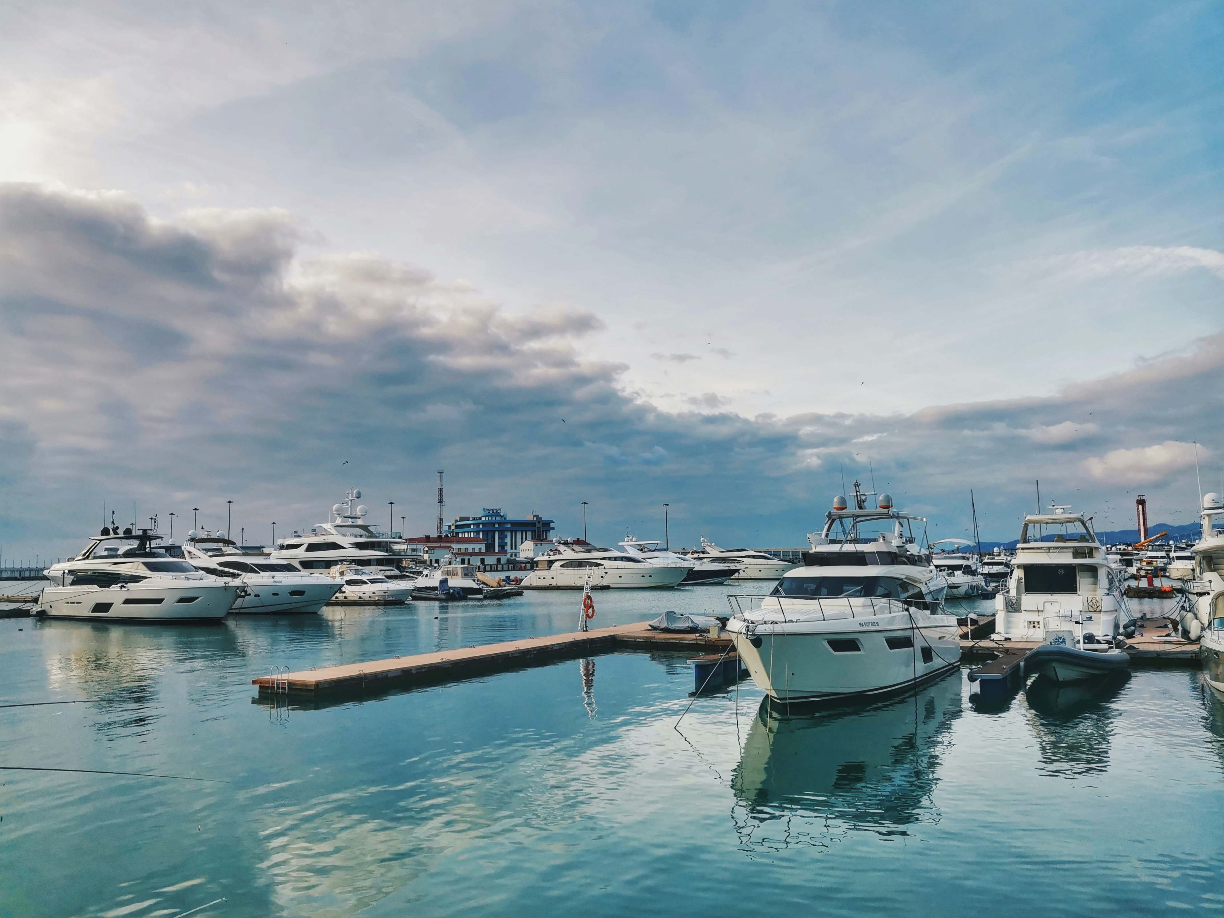 Boats moored to a dock in a marina.