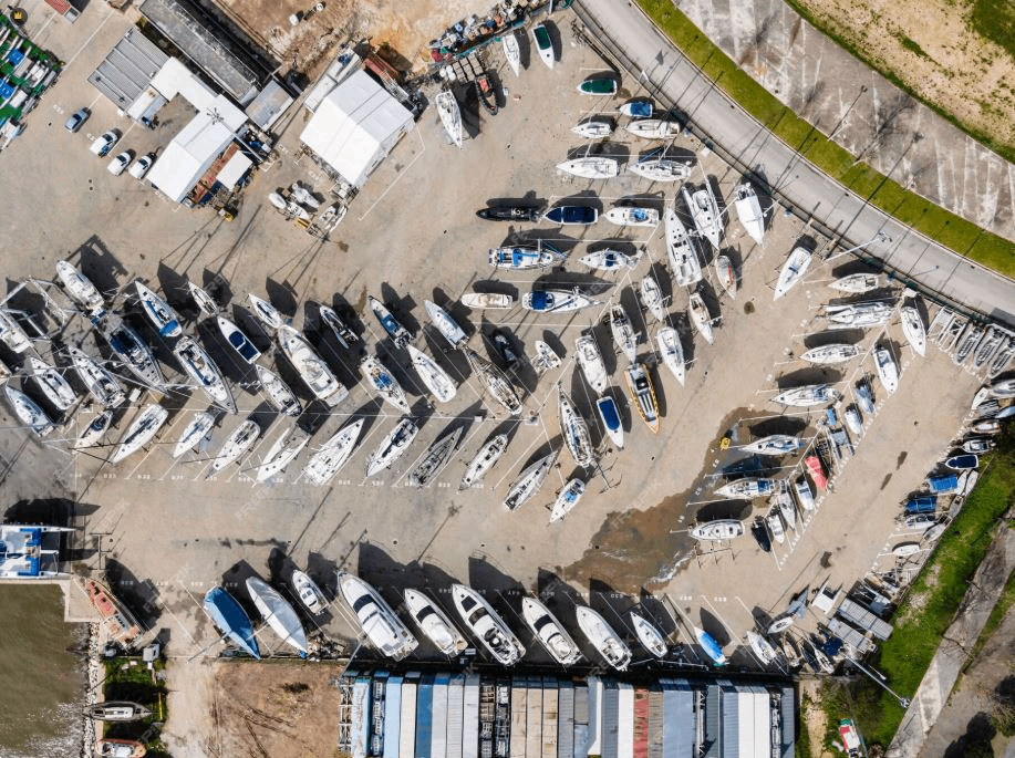 a drone shot of boats in a boat dealership