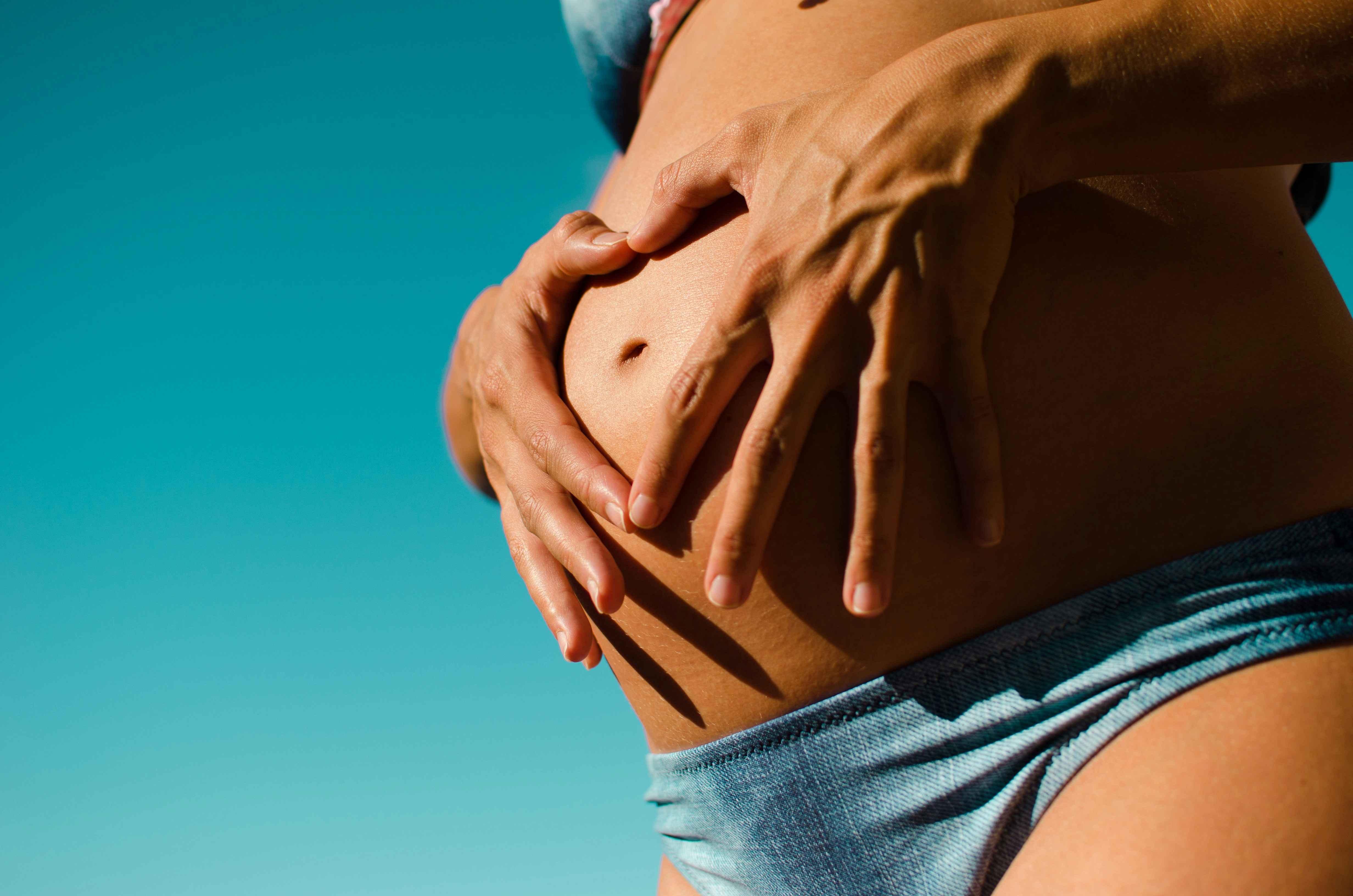 A close up of a pregnant woman's belly.