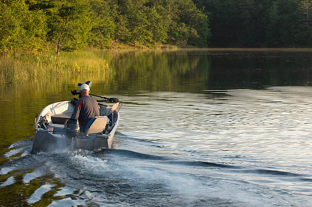 A man operating a small fishing boat.