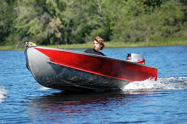 A red and grey boat in planing position.